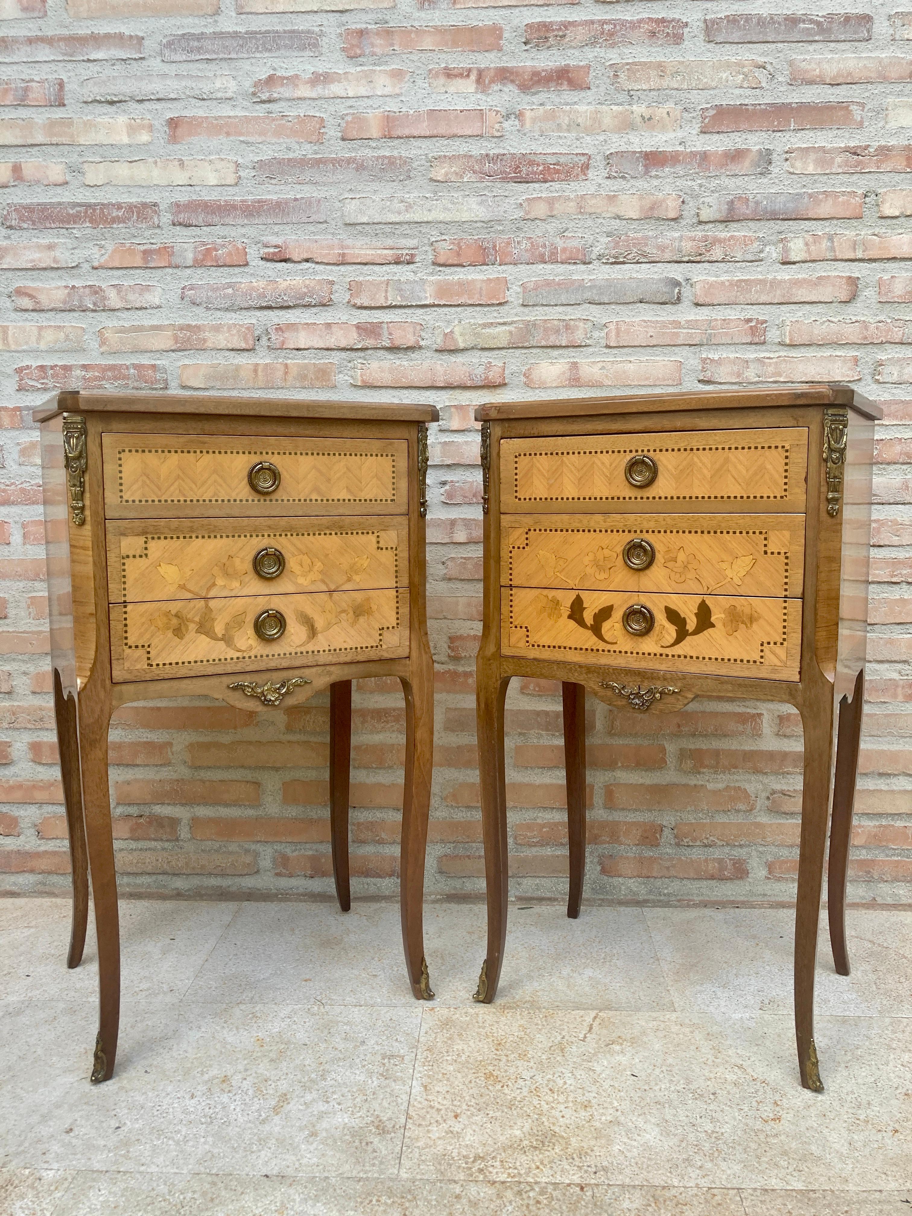 Matching Louis XV style king wooden bedside tables, the tables have three drawers, with floral marquetry on the top and front. The pieces retain their beautiful original covers of floral marquetry and diamond patterns, are adorned with highly