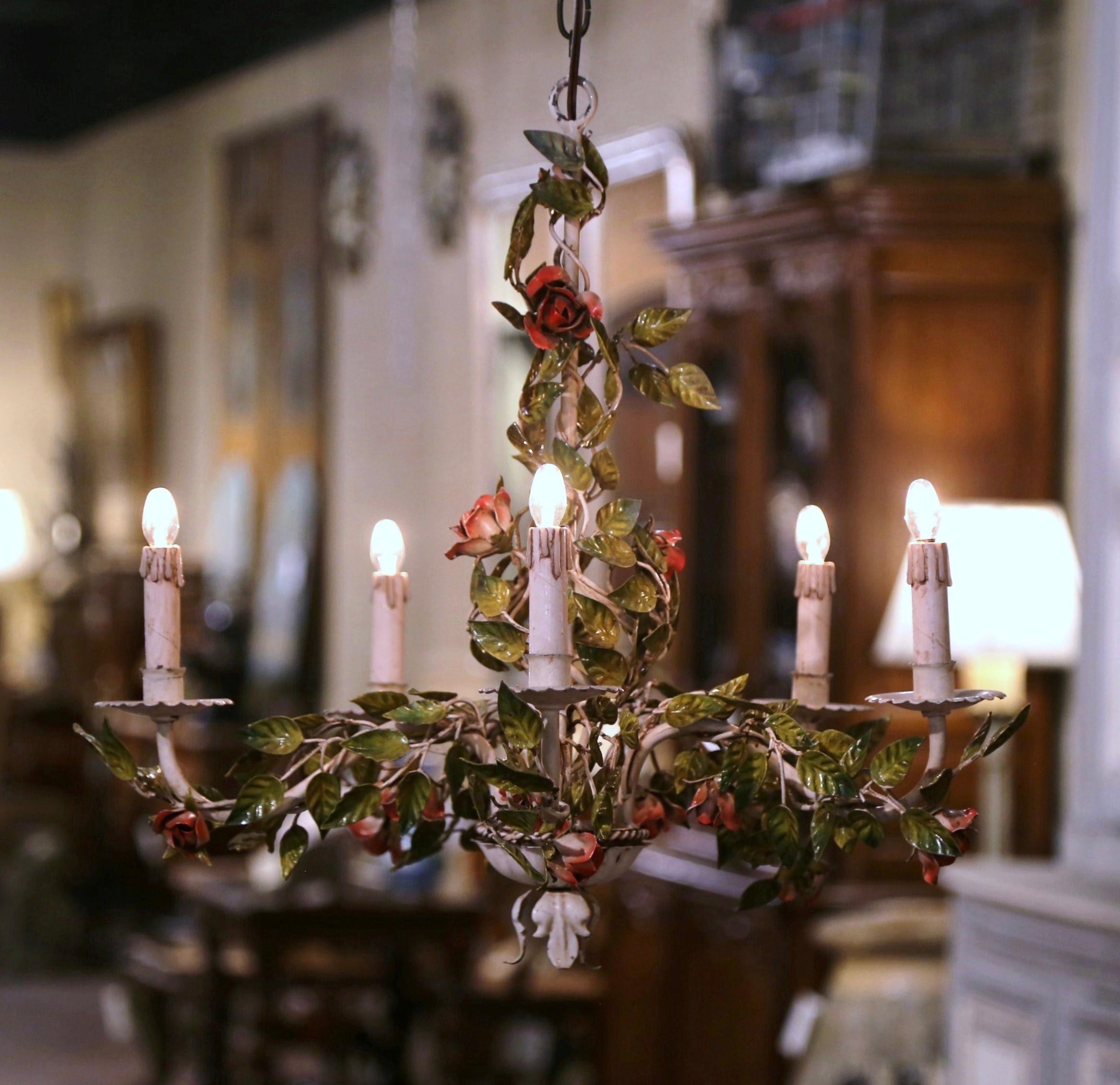 Decorate a girl's room or powder room with this elegant and feminine light fixture. Crafted in France circa 1920, and round in shape, the antique chandelier with a patinated white central frame is decorated with red rose flower motifs, all
