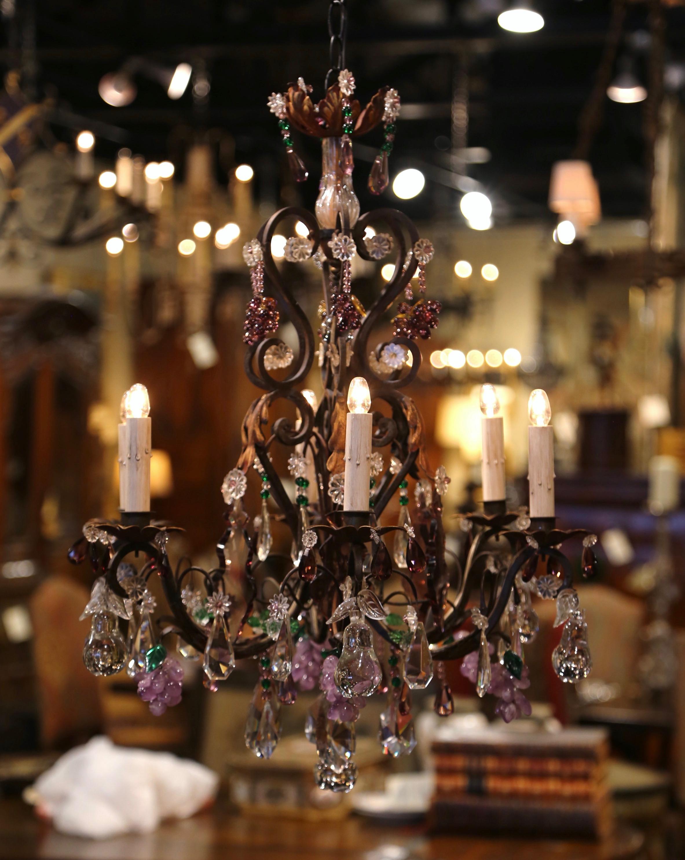 Decorate an entry or a girl's room with this elegant antique light fixture. Crafted in France circa 1920, the colorful chandelier has six metal arms newly wired embellished with metal acanthus leaves, and dressed with candle sleeve covers. The