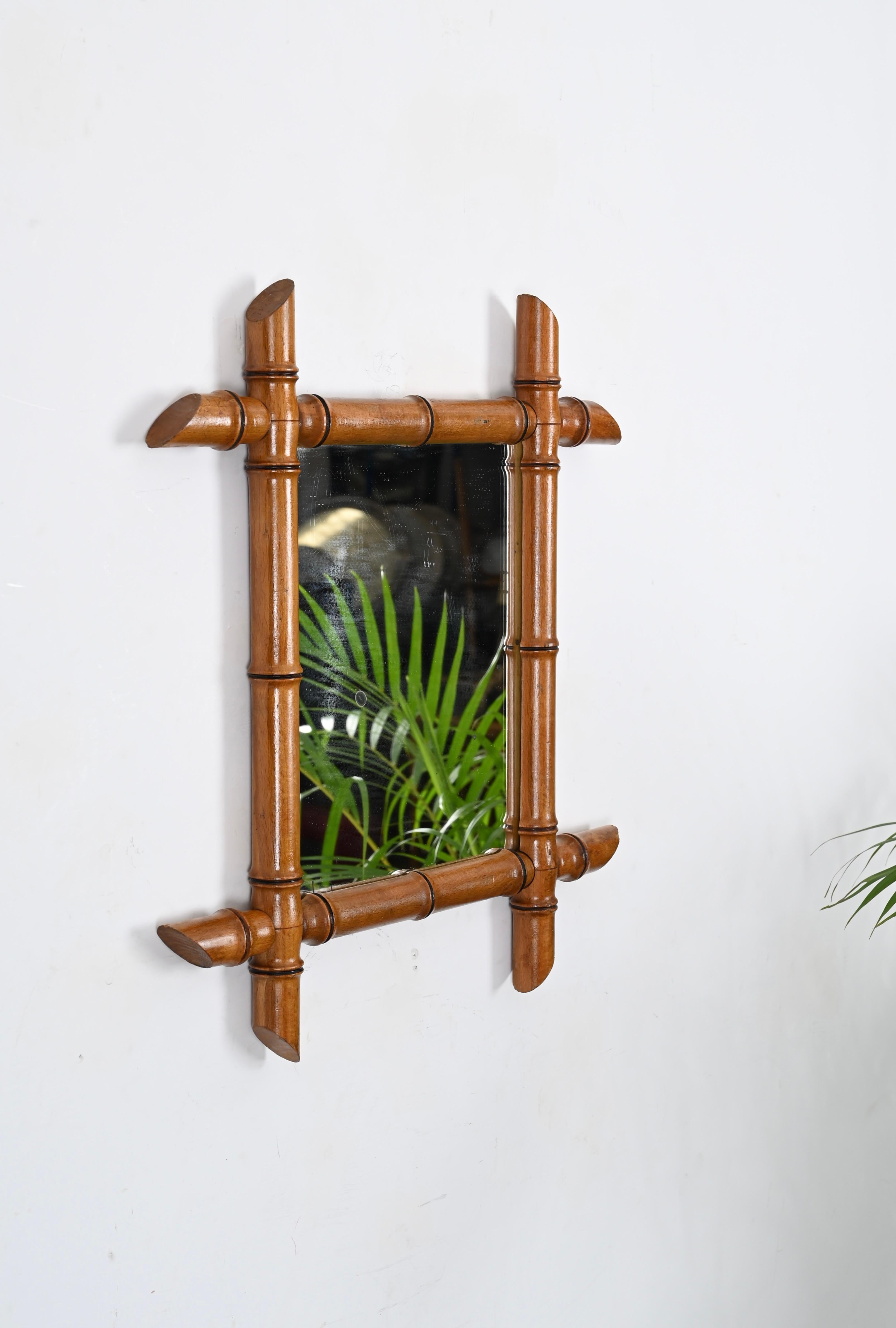 Stunning early 20th century Art Nouveau mirror with beech faux bamboo frame. This wonderful item was produced in France in the early '900.

This piece is very attractive thanks to the gorgeous patina of beech and the sinous lines. The mirror is