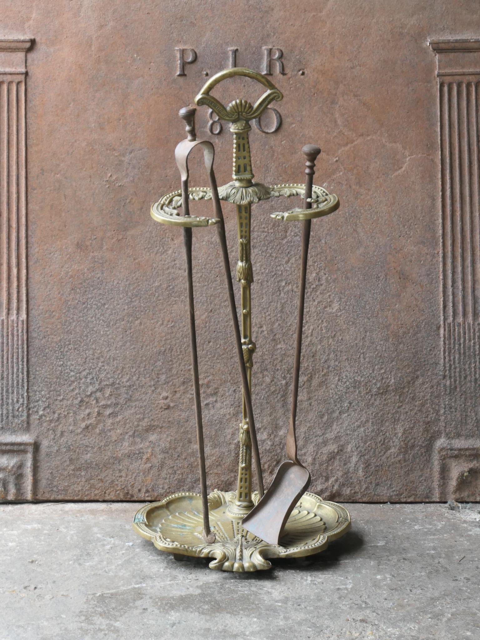 Beautiful early 20th century French Napoleon III Style fireside companion set. The tool set consists of tongs, shovel and stand. The tools and stand are made of brass. The set is in a good condition and is fully functional.