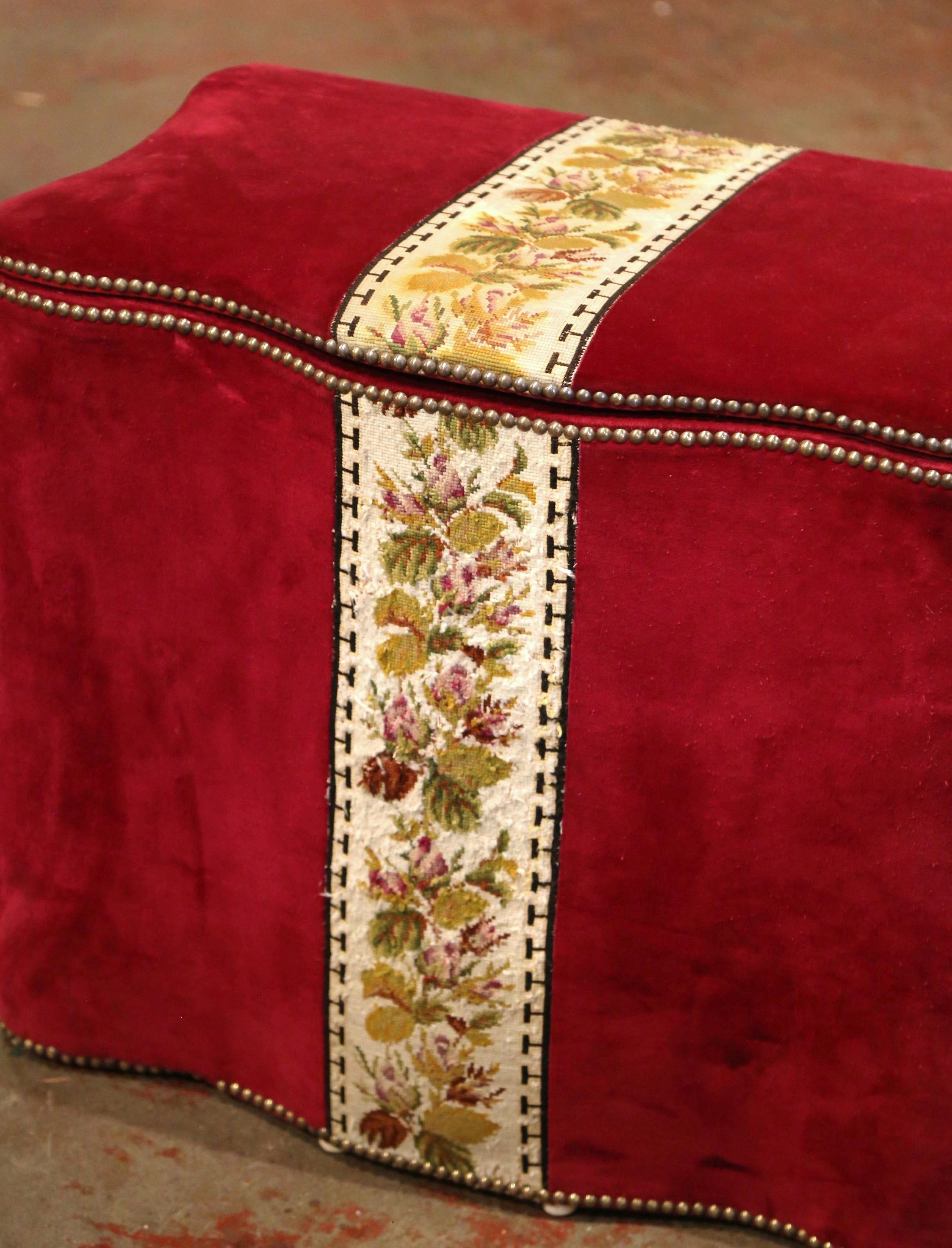 Use this antique trunk for your fireplace wood or dirty laundry; crafted in France circa 1920, the hamper with top features handwoven floral needlepoint strip over a luxurious red velvet upholstery embellished with nailheads. The storage basket is