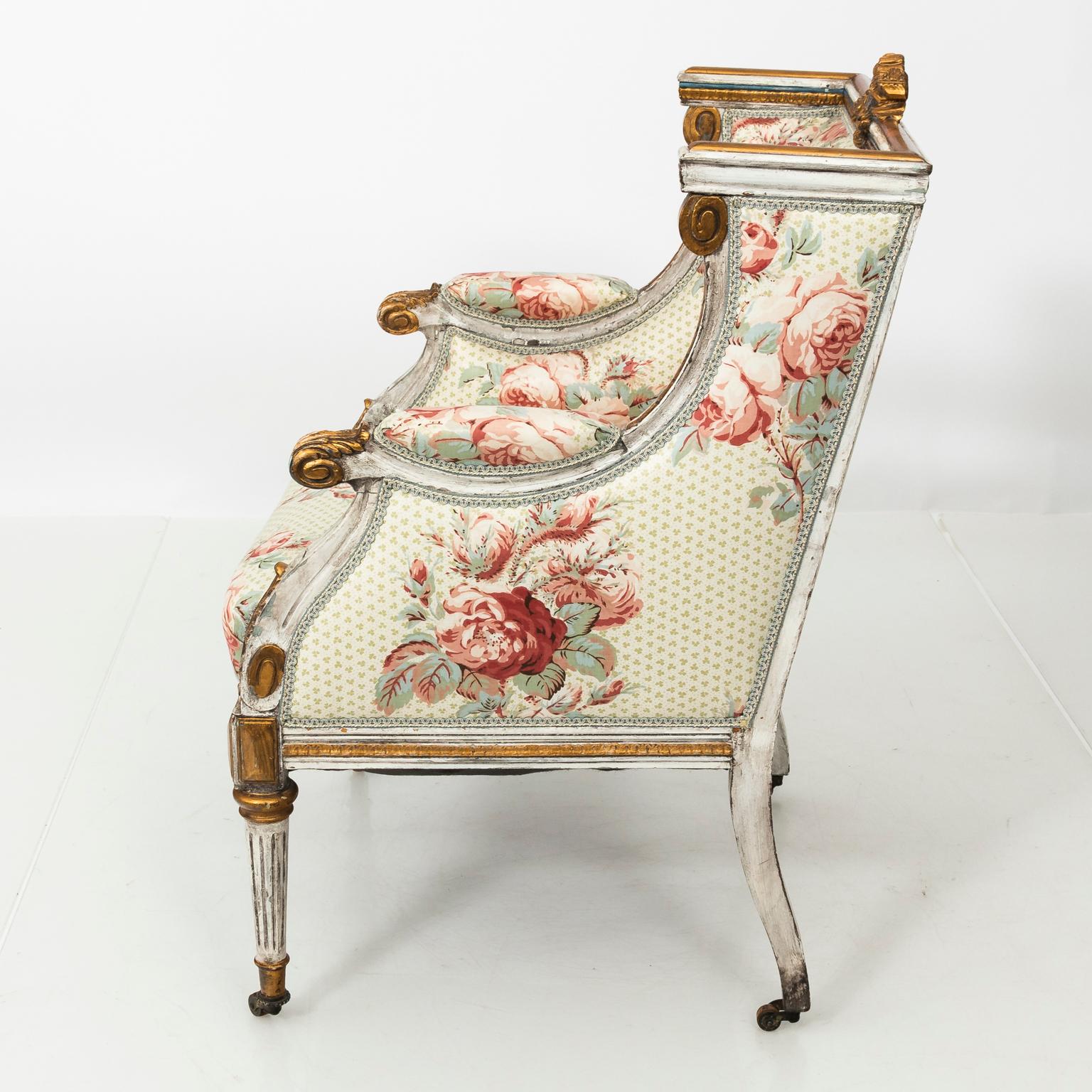 1920-1930 French neoclassical style armchair in Rose Cummings Chinz with original paint and gilded accents on castors.
 