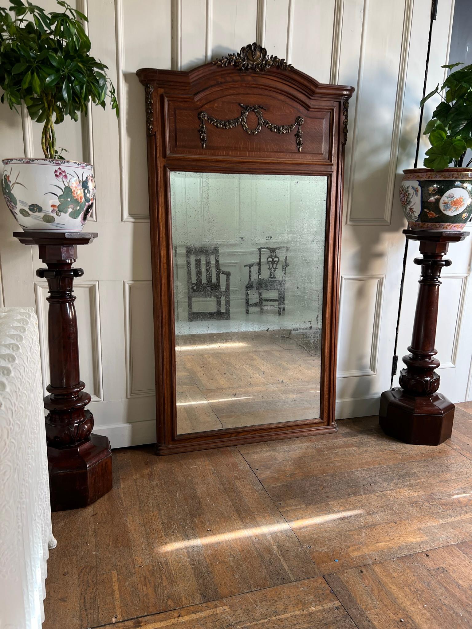 Early 20th century French oak over mantle mirror.

Beautifully foxed mirror with just the right amount of wear to be functional and decorative.

Measurements: 178cm h x 98cm w x 5cm d
(measurements are approximate and are taken at the maximum
