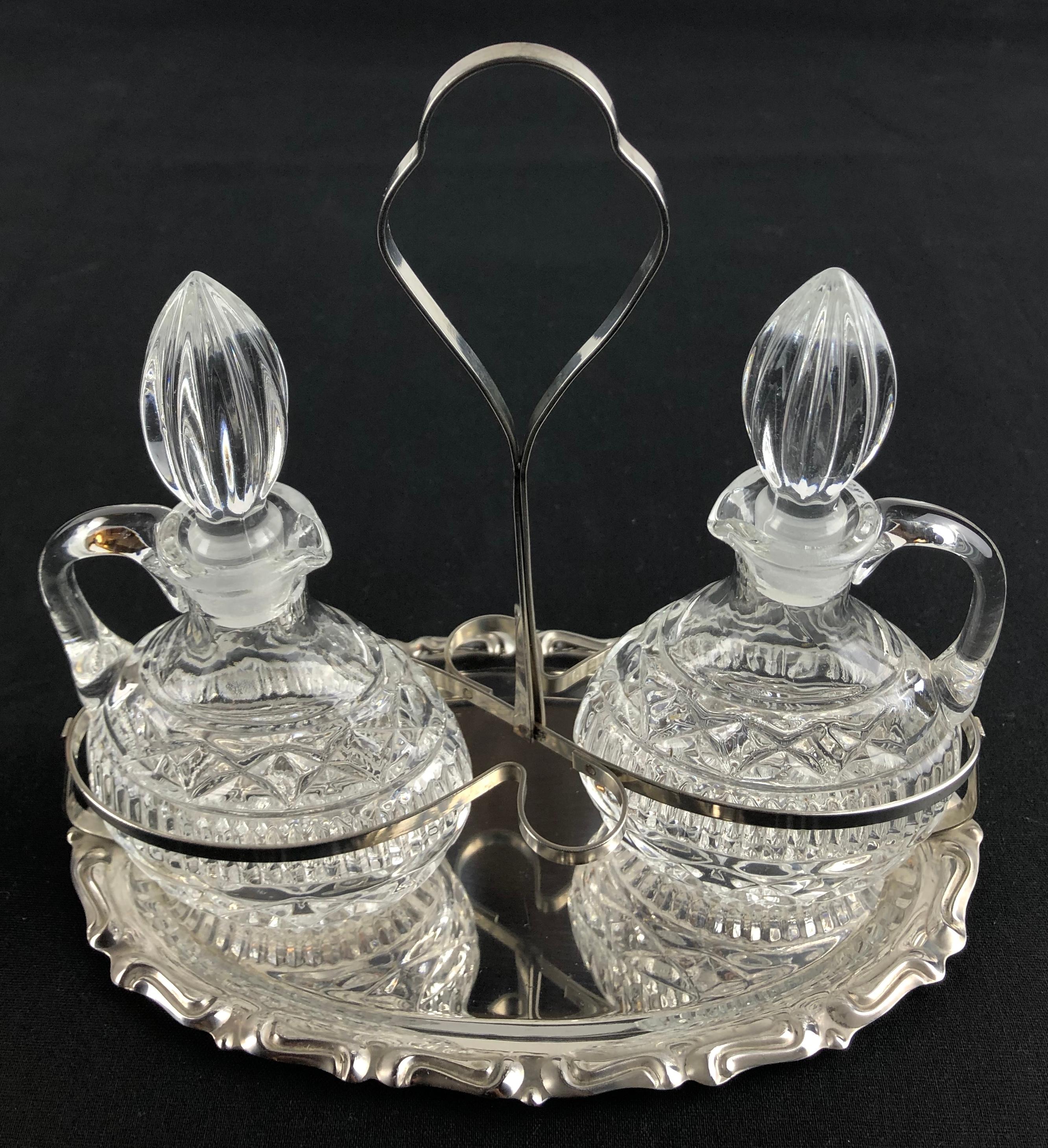Elegant Early 20th century French oil and vinegar cruets or serving bottles in molded-glass with an etched design, can be removed from the silver plated tray for serving purposes. 

This early 20th century French oil and vinegar cruet set features