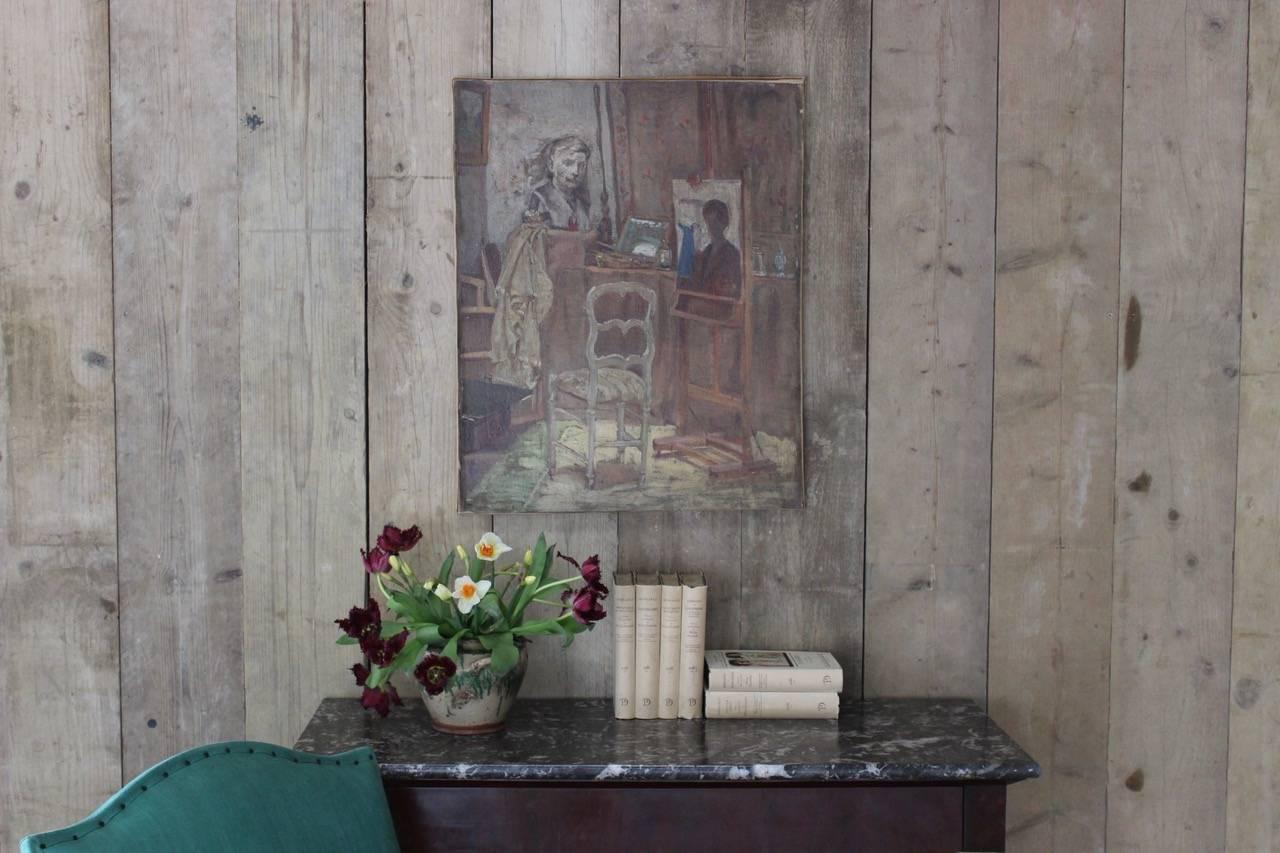 A charming early 20th century French oil on canvas painting of an artist's studio.