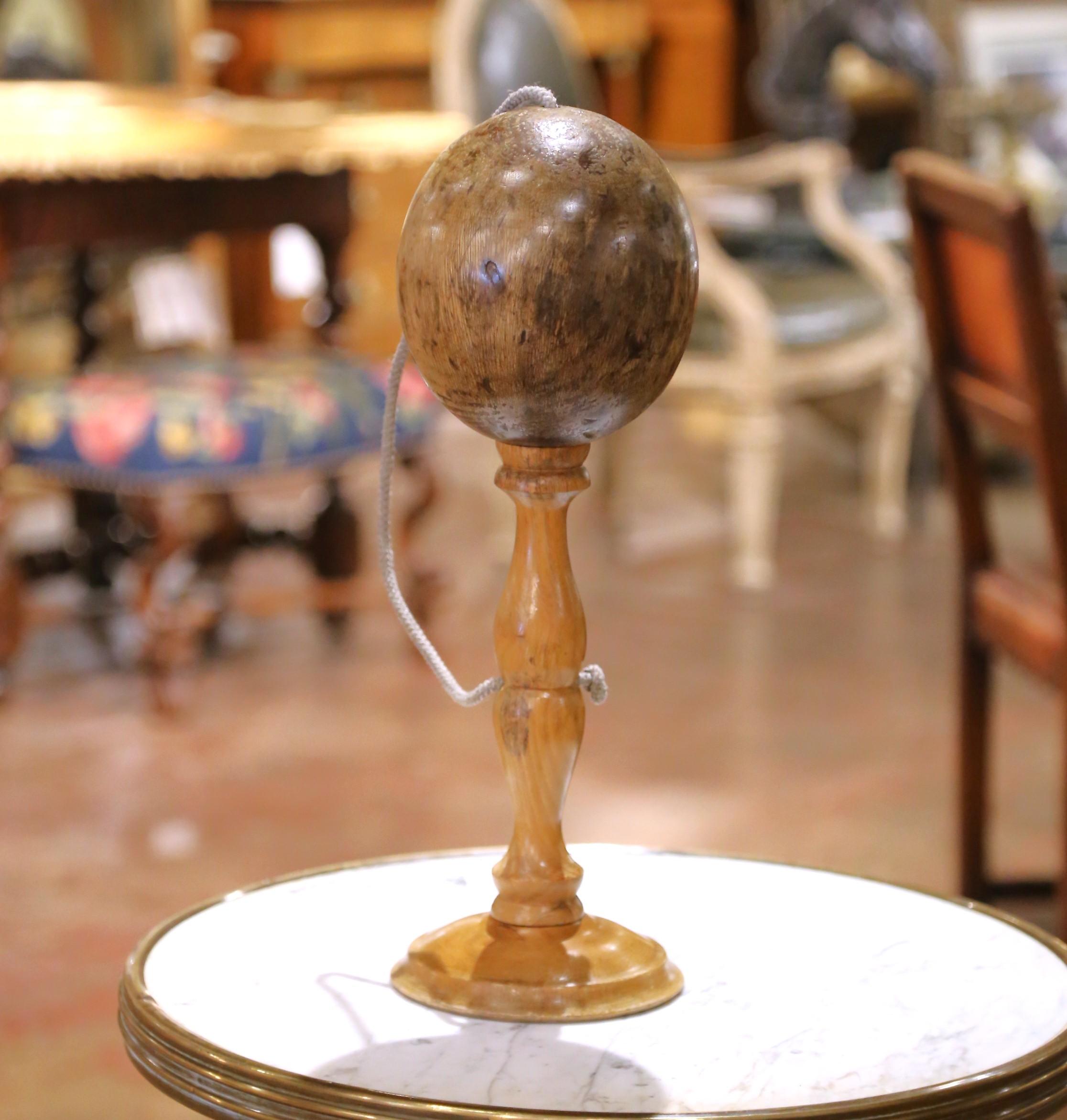 
Apportez une touche de charme rustique français à votre collection avec ce grand bilboquet tourné à la main, fabriqué en France vers 1920. Ce jeu traditionnel de gobelets et de balles comporte une balle en bois d'olivier magnifiquement patiné,