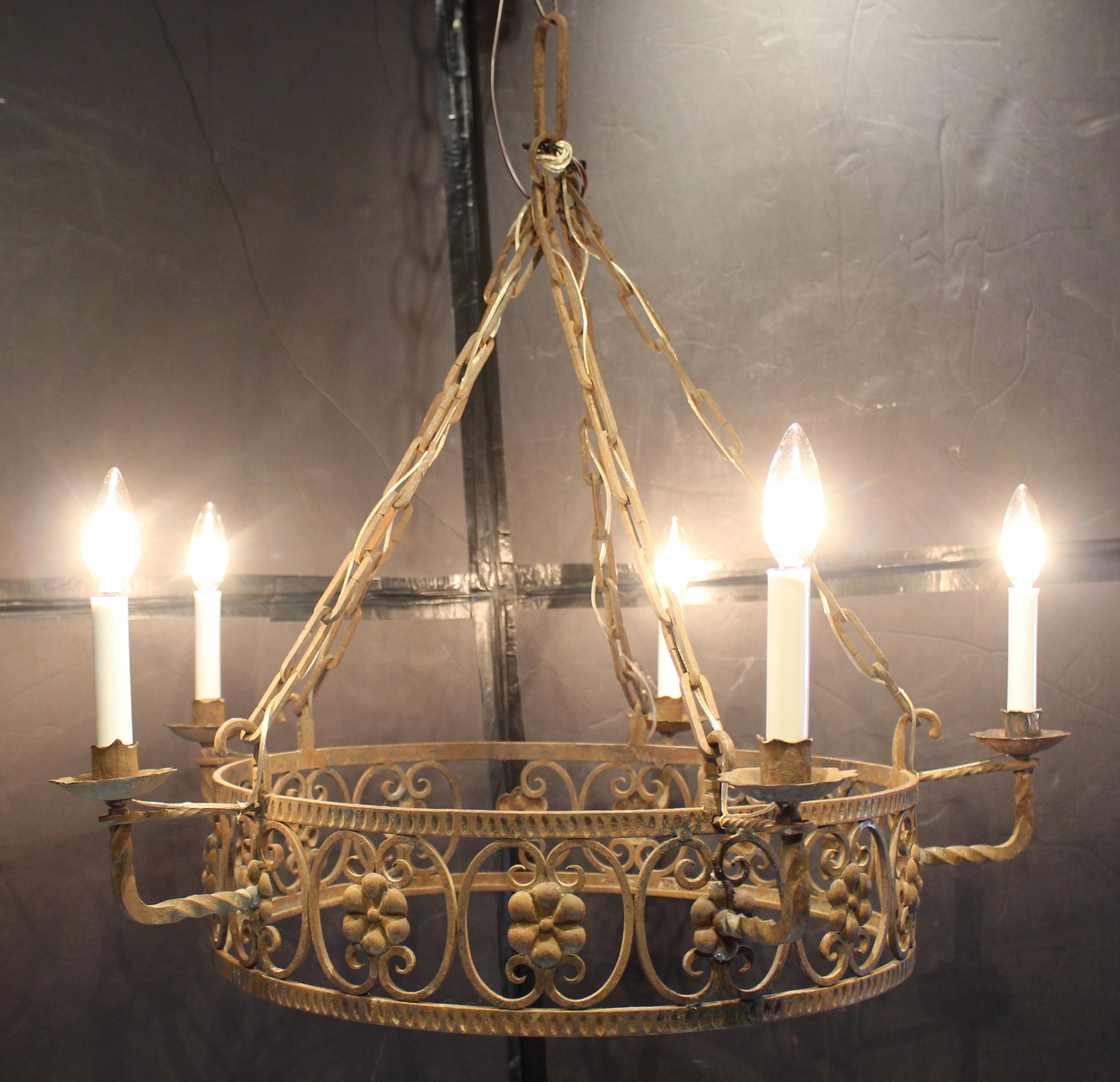 Early 20th century wrought iron 5-candle chandelier, French or Italian. Newly electrified. Floral cast brosses entwined in reverse c-scrolls. Provenance: Estate of Katharine Reid, Cleveland Art Museum former director, purchased from Summerland, CA