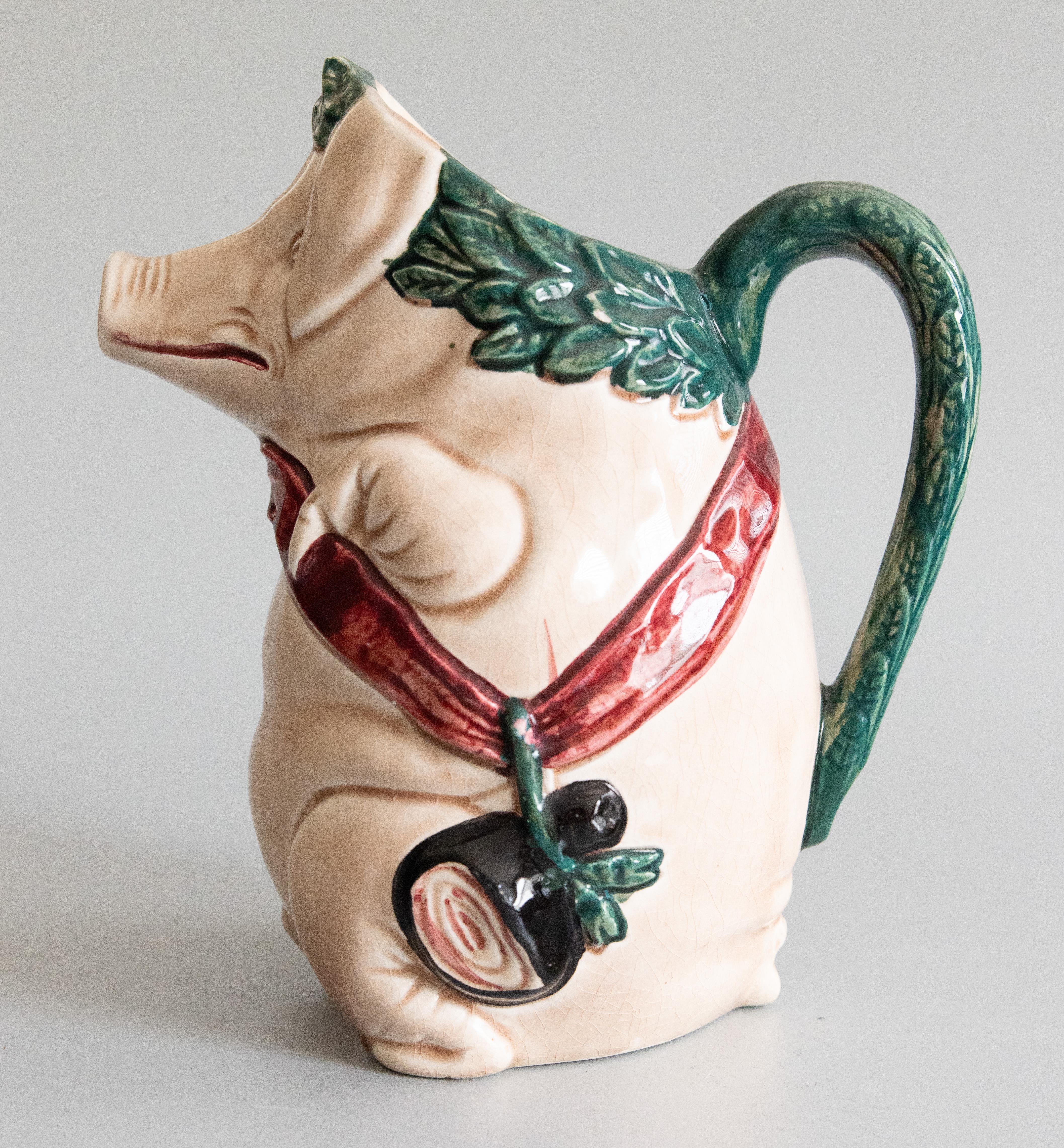 A charming antique French majolica barbotine pig pitcher by Orchies, circa 1920. Maker's mark on reverse. This highly collectible pitcher, titled 