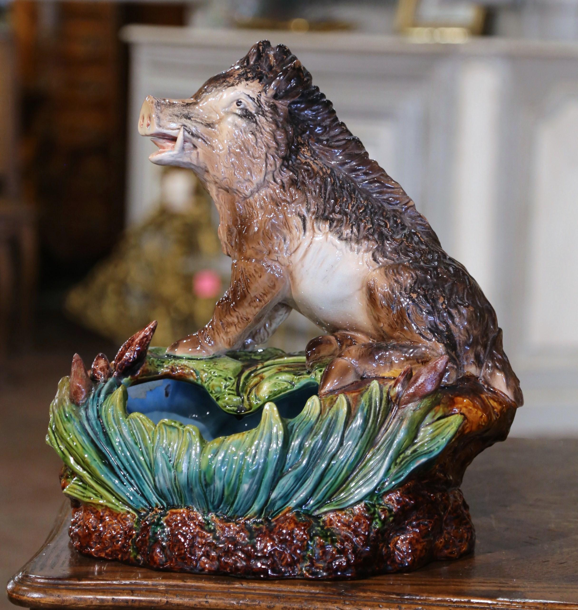 Decorate a table or console with this colorful antique majolica planter. Crafted in France, circa 1920, the large, decorative ceramic composition features a wild boar sited on the edge of a flower pot decorated with reed motifs. The large whimsical