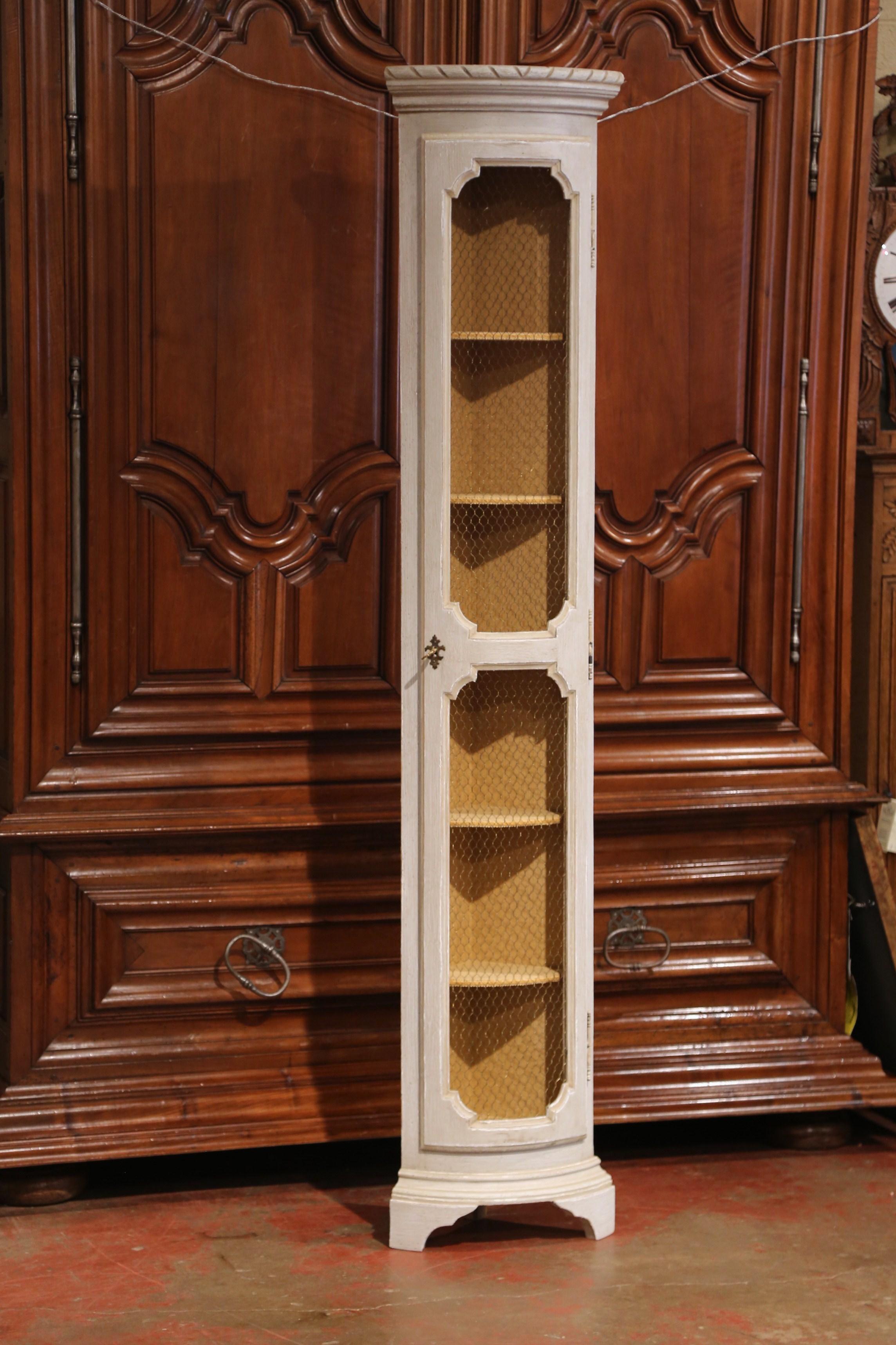 Place this tall and narrow corner cabinet in a powder room or any other available corner in your house for display or storage. Crafted in France circa 1920, the skinny walnut 
