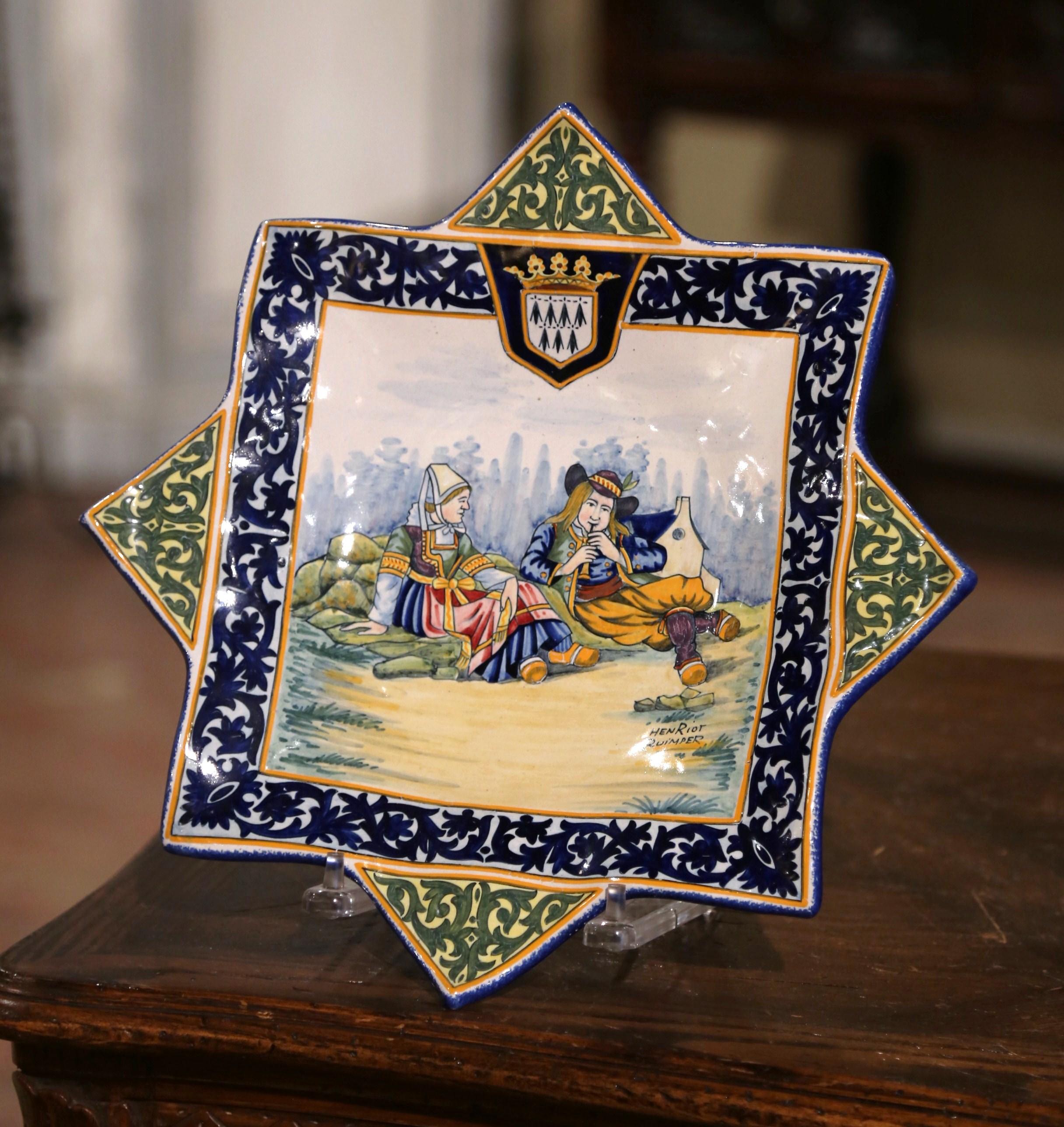 Decorate a kitchen wall or a shelf with this unusual antique star-shape platter. Created in France circa 1910, the large ceramic plate with 