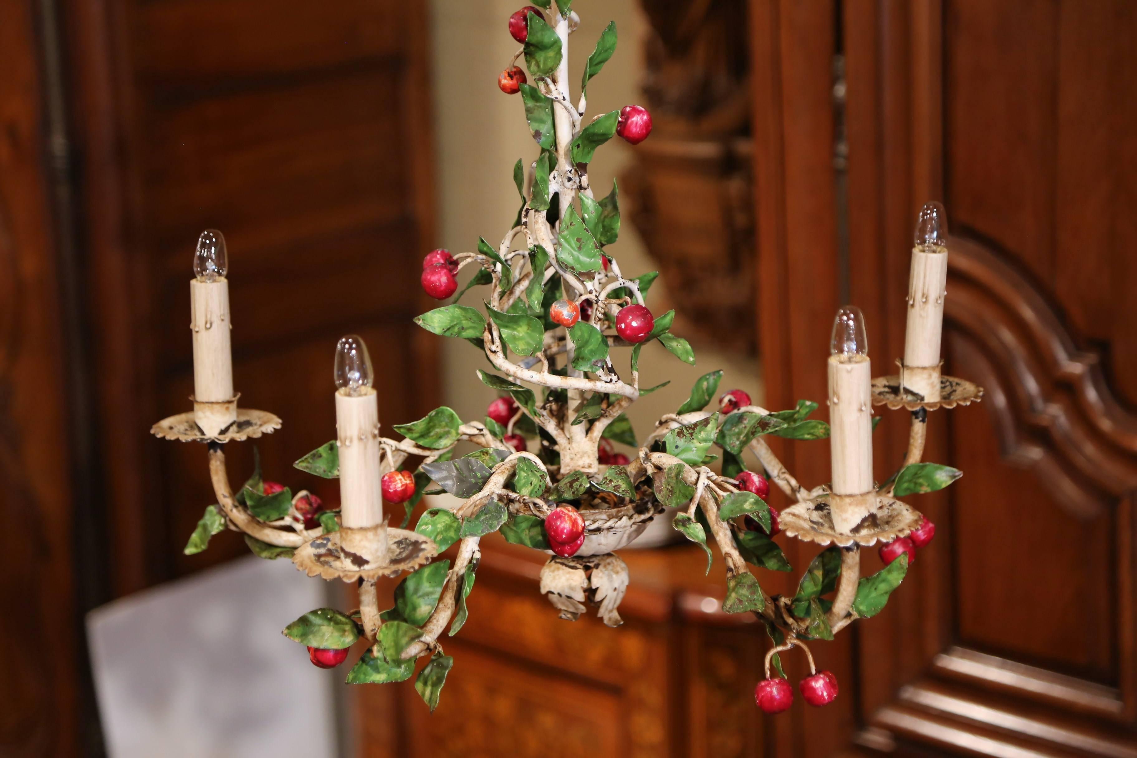 This elegant, antique chandelier was crafted in France, circa 1920. The small, charming hanging light fixture has five lights and is embellished with red cherries and green leaves throughout the piece. The round chandelier is in excellent condition