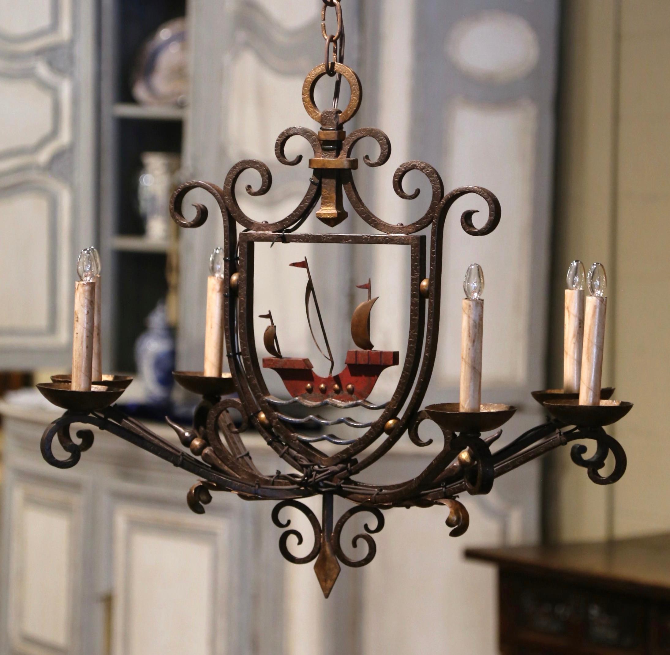 Decorate a kitchen island or breakfast room with this colorful antique light fixture. Forged in France, circa 1920 and oblong in shape, the fixture has six iron arms with newly wired lights, each dressed with decorative candle sleeve covers. At its