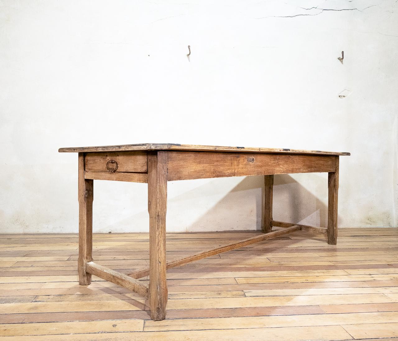 A charming early 20th century French painted refectory table. Raised on four chamfered legs, united by stretchers - demonstrating drawers to each end of the apron. The table displays a sunbleached oak base with a unique painted gridlike design to