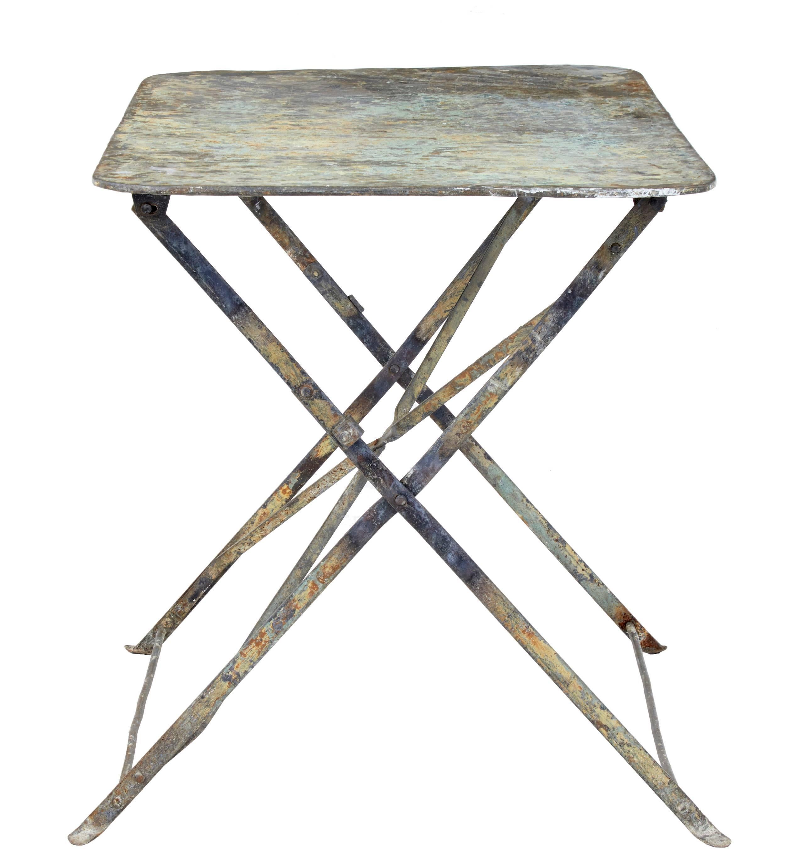 Lovely French country table, circa 1920.

Beautiful colored top which is now showing various layers of previous paint.

Fold up mechanism works smoothly to open out to a sturdy table.

Ideal for use in a garden room or outside.