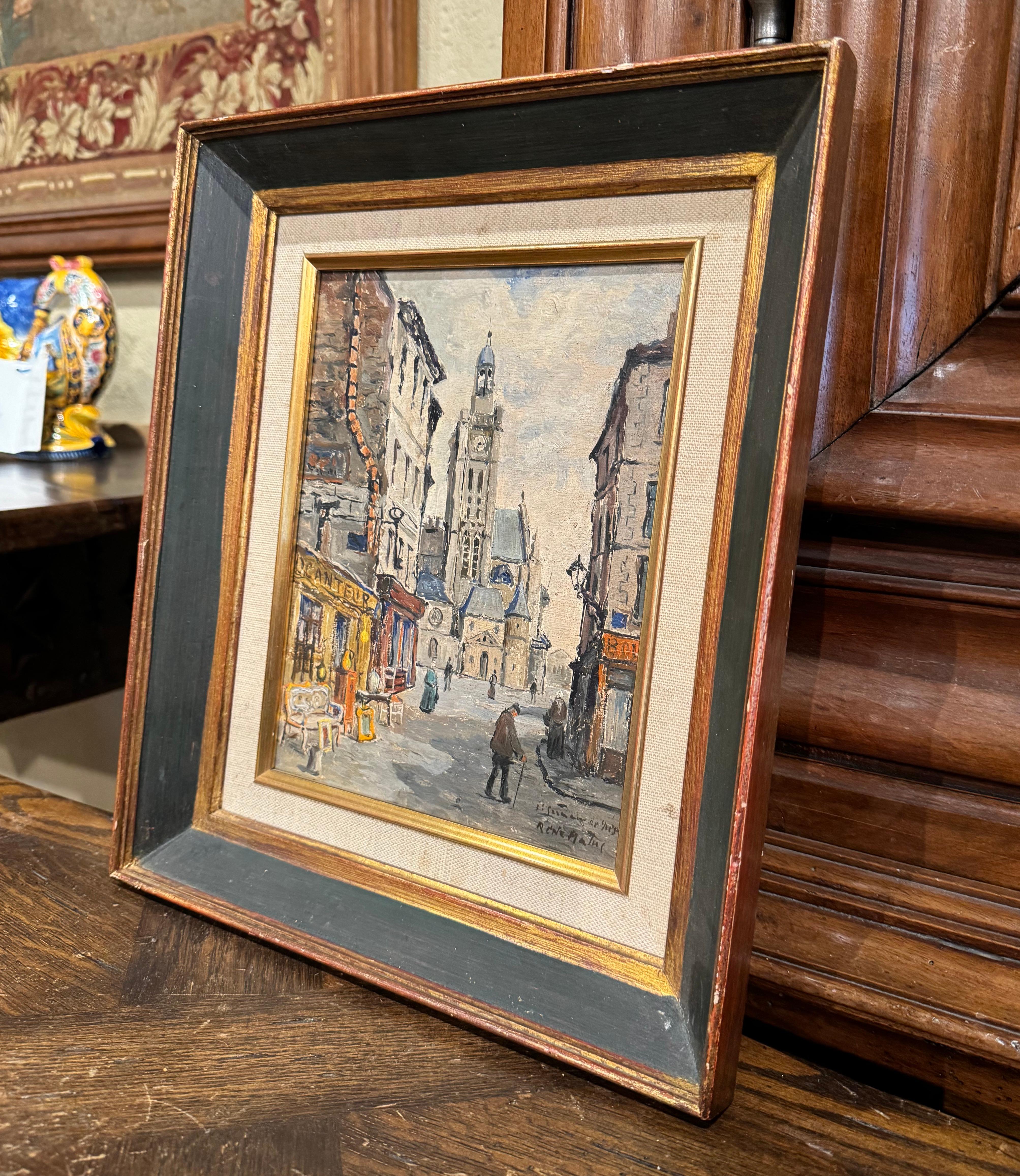Decorate a study, living room or den with this beautiful vintage Paris painting featuring Saint Germain des Pres. Created in France circa 1930 and set in the original two-tone wooden frame dressed with a liner, the hand painted artwork on board