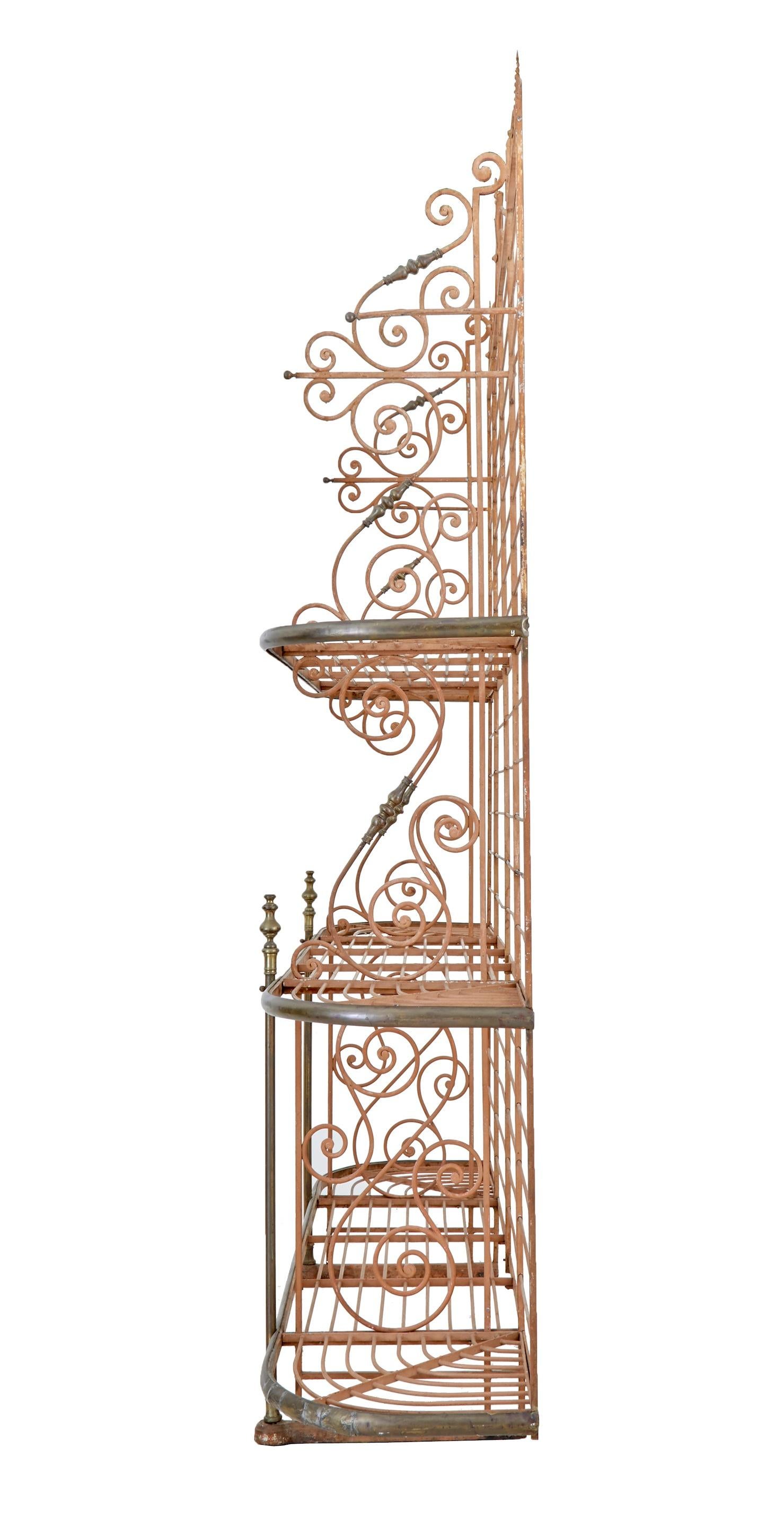 Early 20th century French Parisienne boulangers bread rack, circa 1900.

Superb quality boulangerie baguette rack. Made from iron with various detailing such as twists and monkey tails. 3 shelves with 2 partitions running the full height to