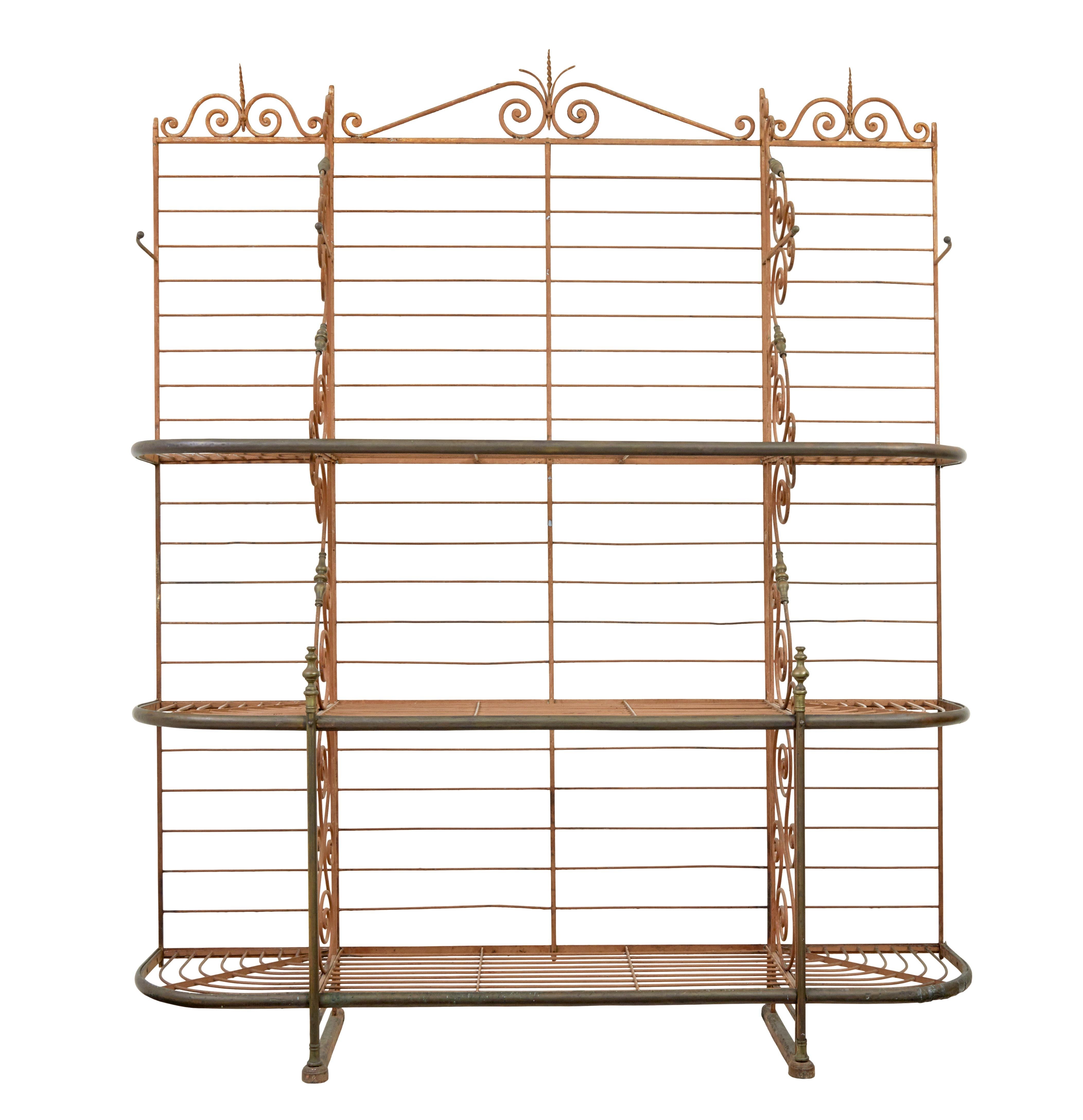 Early 20th century French Parisienne boulangers bread rack circa 1900.

Superb quality boulangerie baguette rack, of large proportions.  Made from iron with various detailing such as twists and monkey tails. 3 shelves with 2 partitions running the