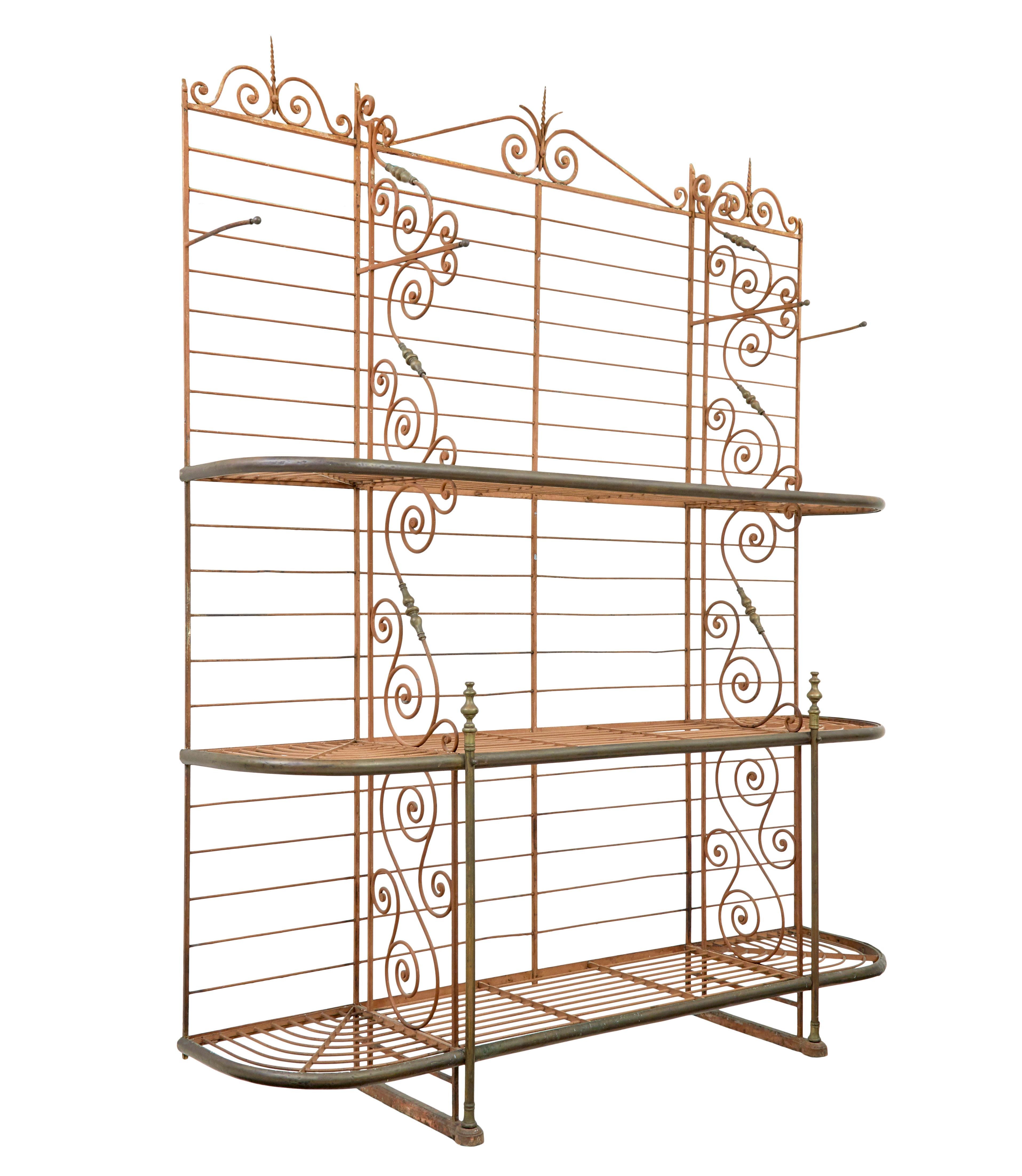 Early 20th century French parisienne boulangers bread rack circa 1900.

Superb quality boulangerie baguette rack, of large proportions.  Made from iron with various detailing such as twists and monkey tails. 3 shelves with 2 partitions running the