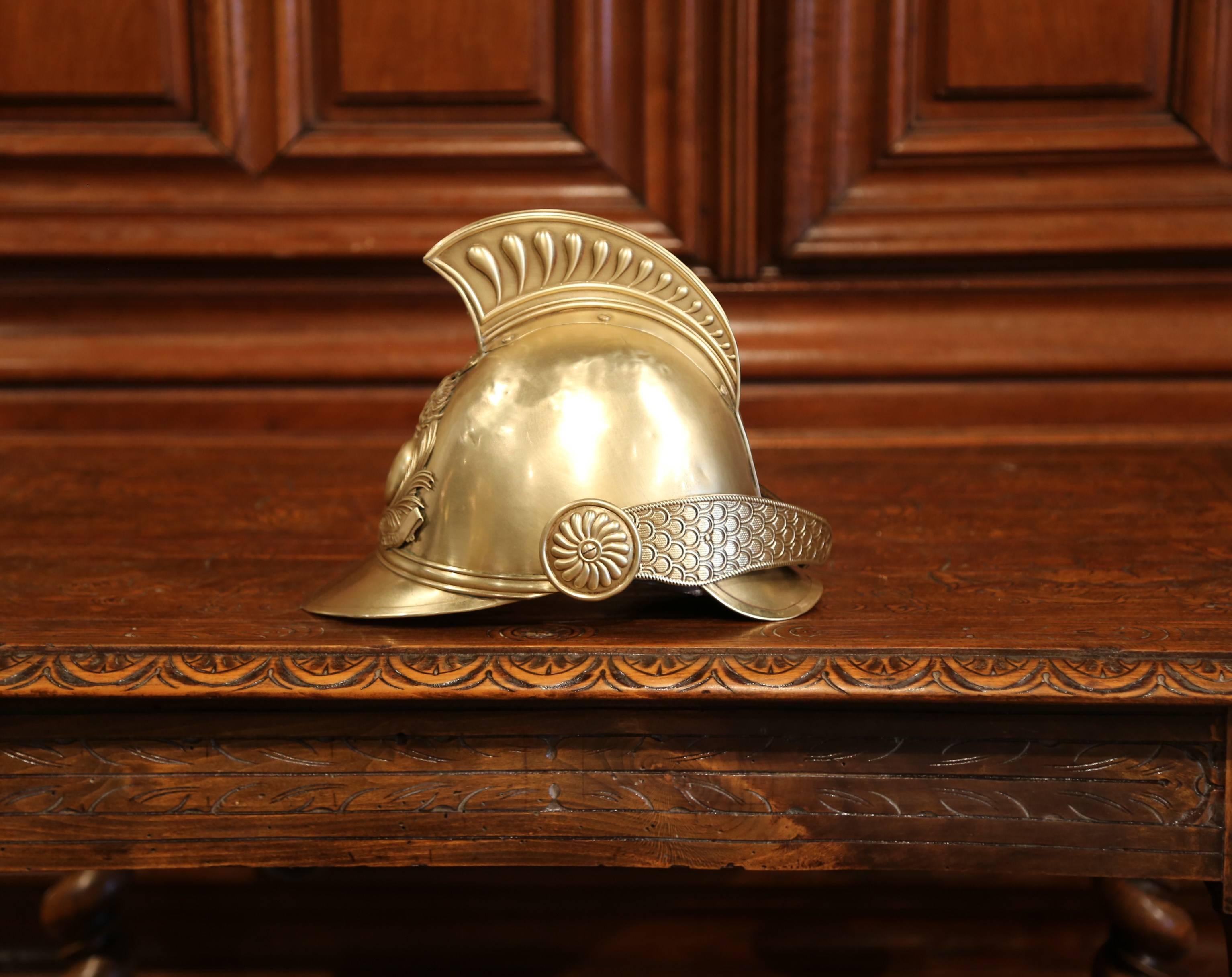 Beautiful antique fireman helmet from France; crafted circa 1930, the helmet features the original brass and leather straps and is signed on the front: 