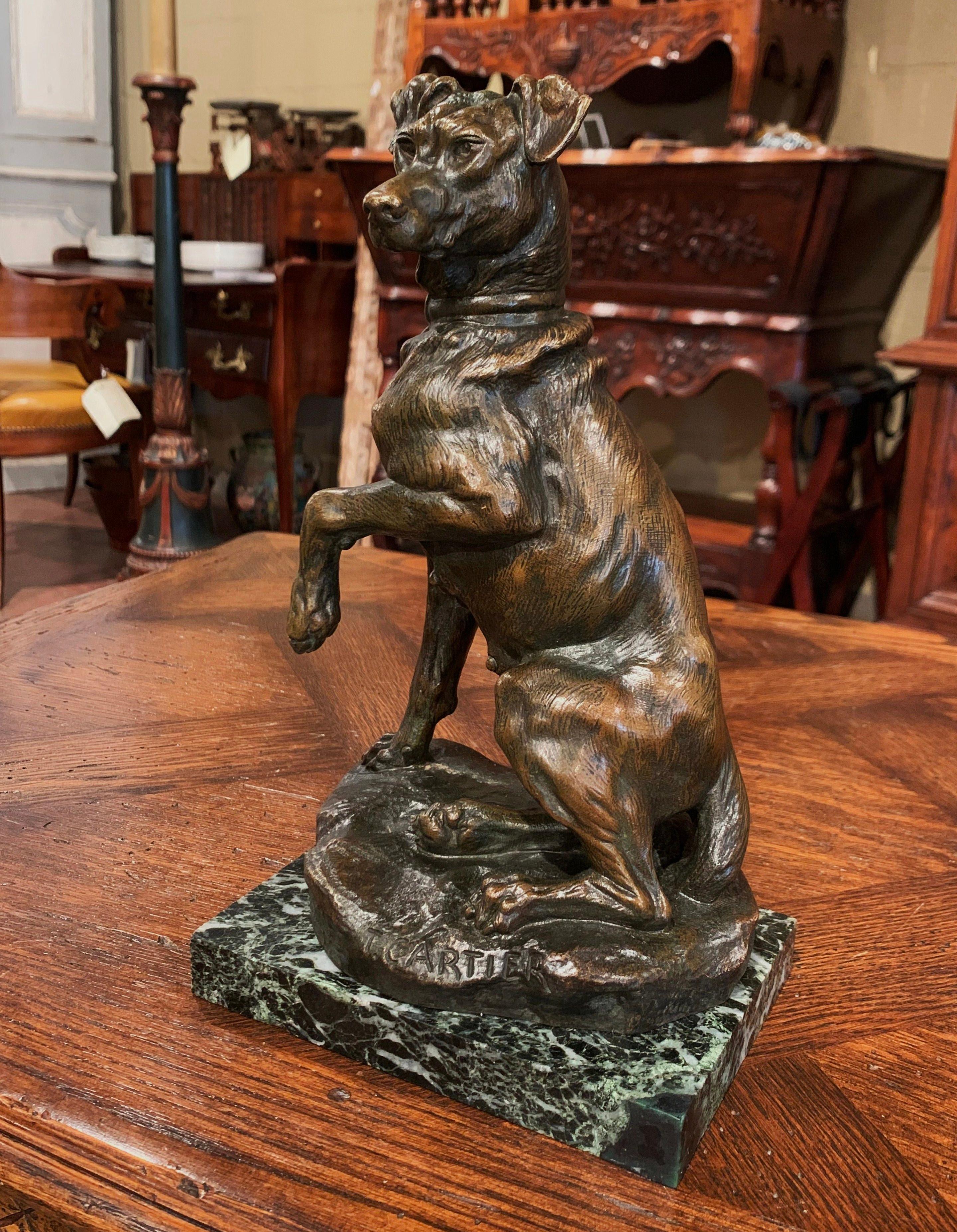 Cette magnifique figure en bronze antique a été sculptée en France vers 1920. La sculpture repose sur une base en marbre vert foncé et représente un Labrador de chasse assis sur son arrière-train et posant avec la patte avant gauche levée. L'œuvre