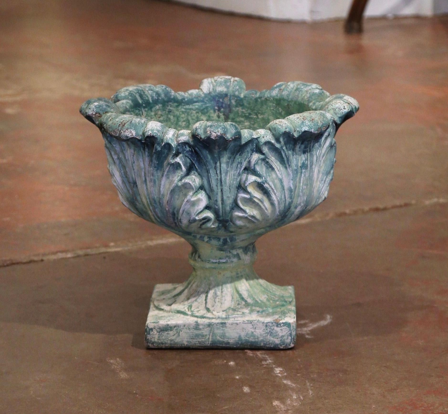 Place this elegant antique planter on your patio for a timeless flower display. Crafted circa 1920, the large, sturdy stone jardinière sits on a solid square base and features a wide carved urn embellished with acanthus leaf motifs over a scalloped