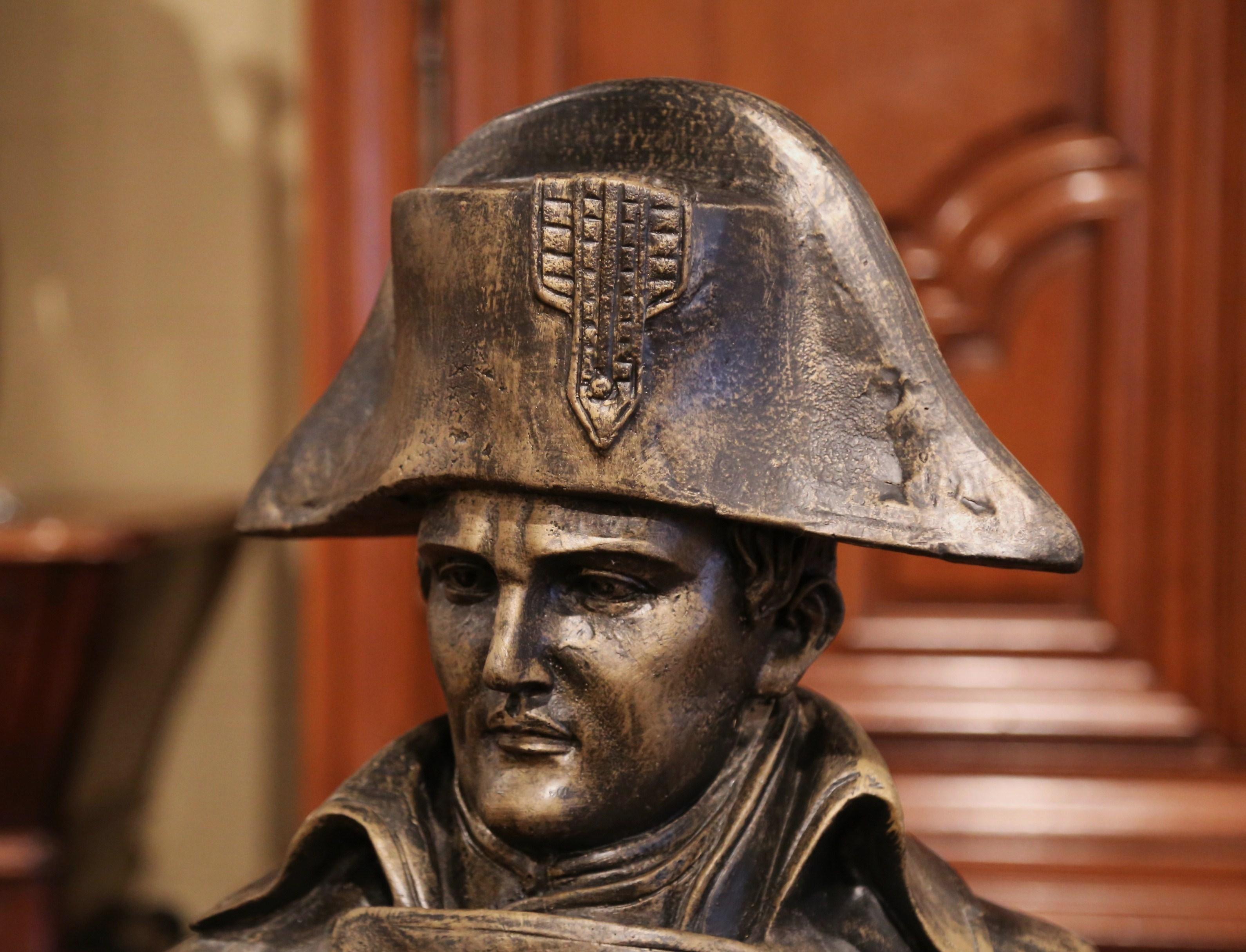This large antique bust was found in Versailles France; created circa 1920, the tall sculpture depicts the French Emperor Napoleon I over the famous eagle emblem. He is features with his traditional bicorne hat and a large leather like jacket over