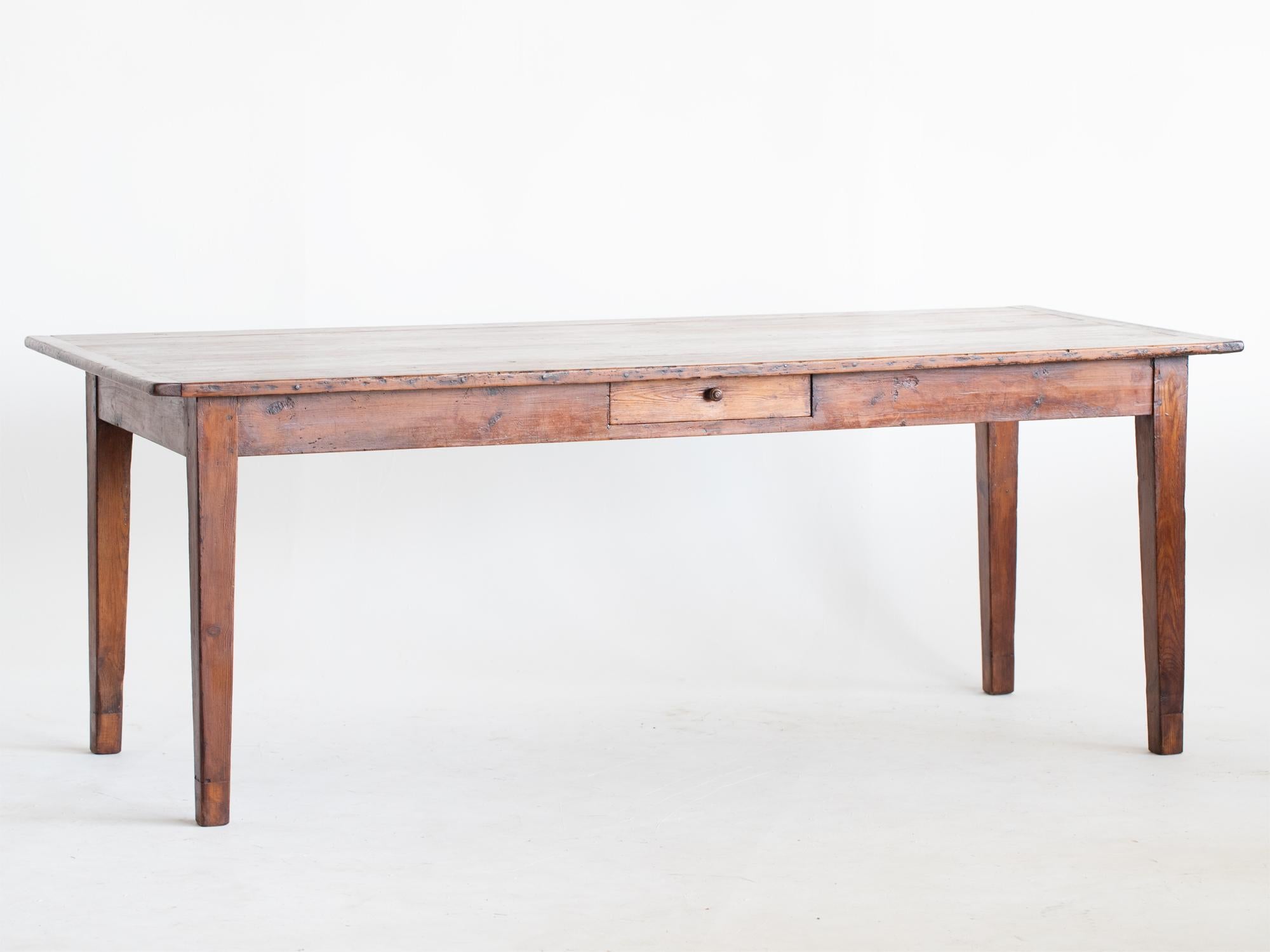 A stained pine farmhouse table with deep-drawer to one side. French, early 20C.

Stock ref. #2211

In good sturdy order.

Note: considered restoration work ensures our tables' suitability for modern dining whilst retaining their original charm and
