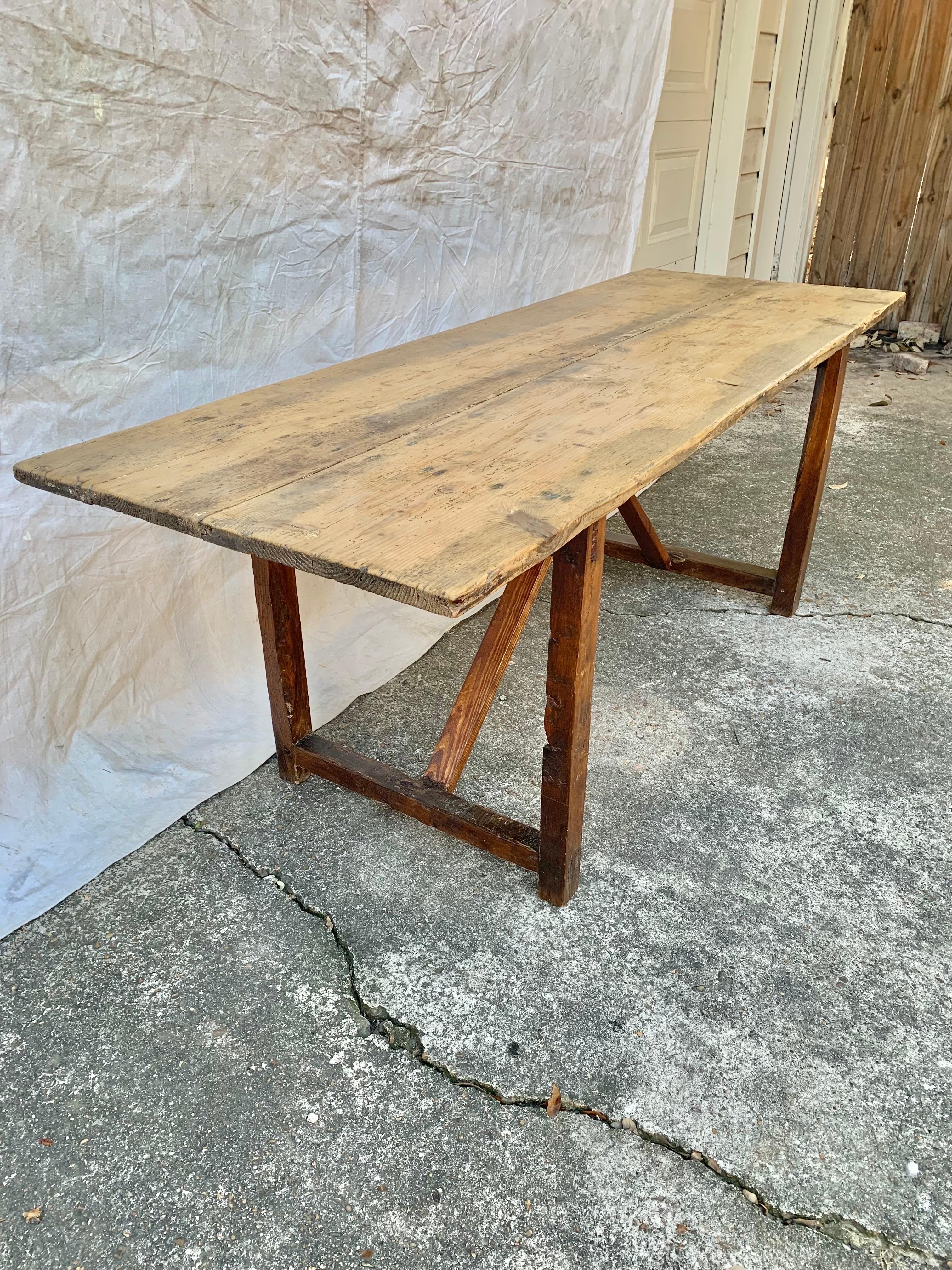Found in the South of France, this French Trestle Table was crafted from old growth pine by French artisans in the early 1900's. The table features a 1