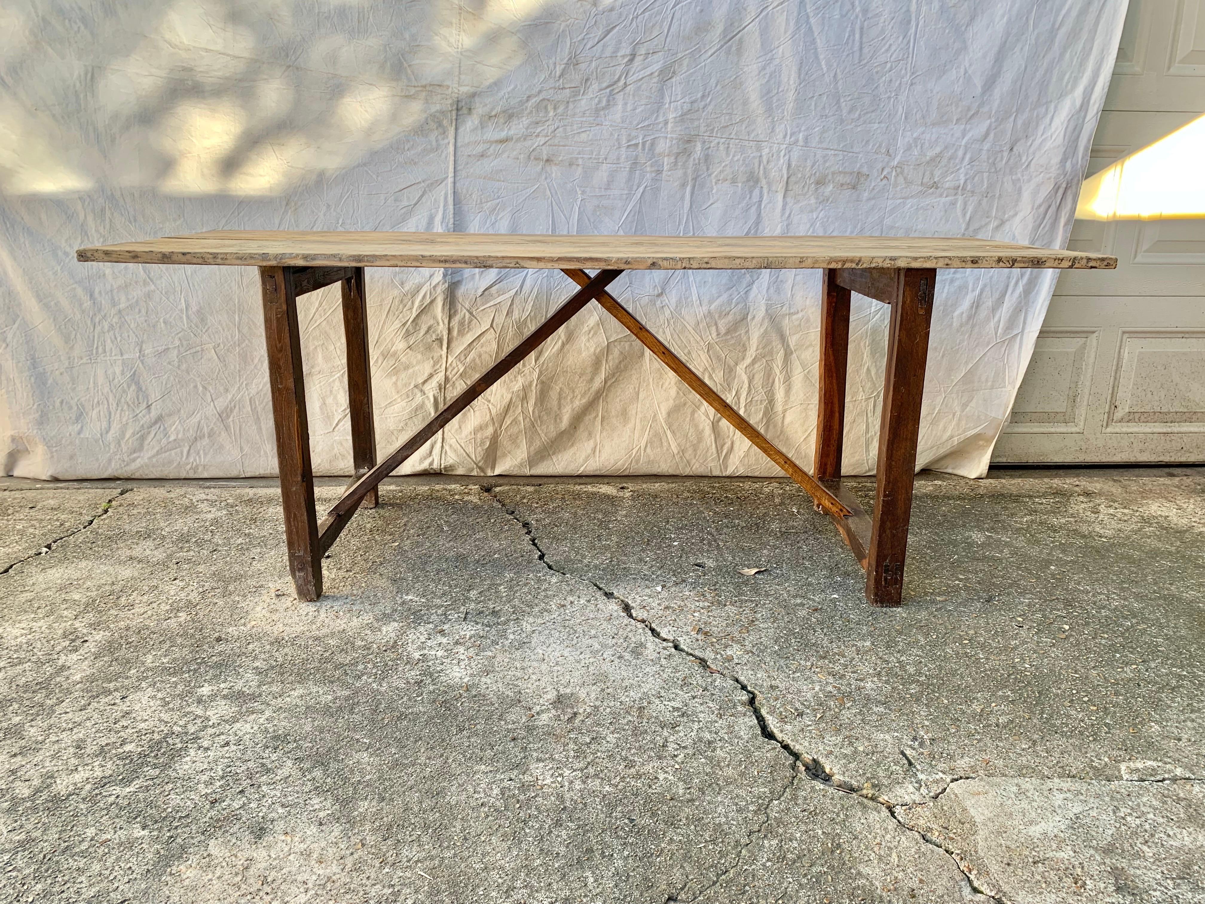 Found in the South of France, this French Trestle Table was crafted from old growth pine by French artisans in the early 1900's. The table features a 1