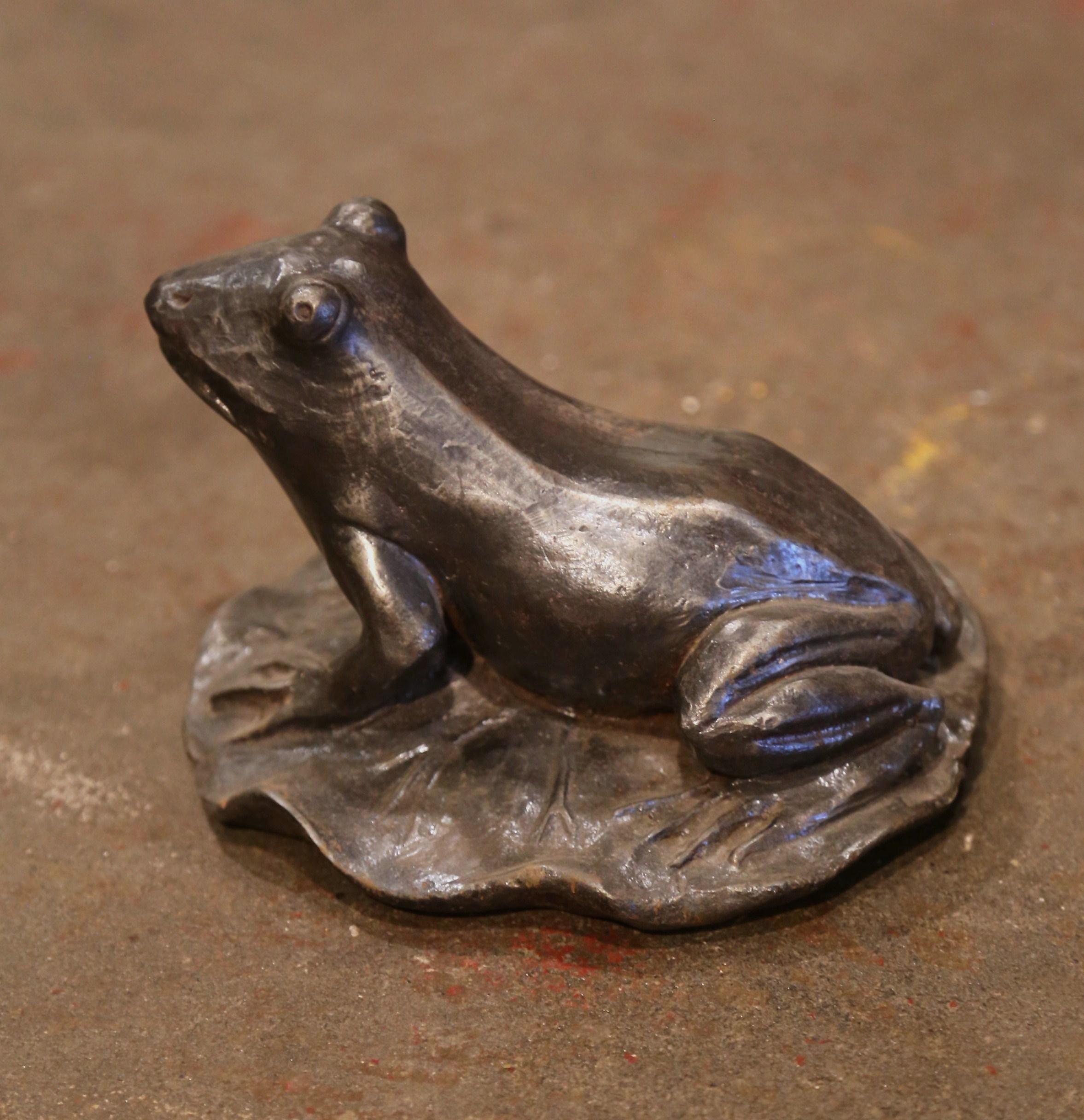 Crafted in France circa 1930, the sculpture depicts a frog resting on his back legs on a lily leaf. The frog is in excellent condition and adorns a rich polished silver and black steel finish. Use it outside to decorate a back yard or a