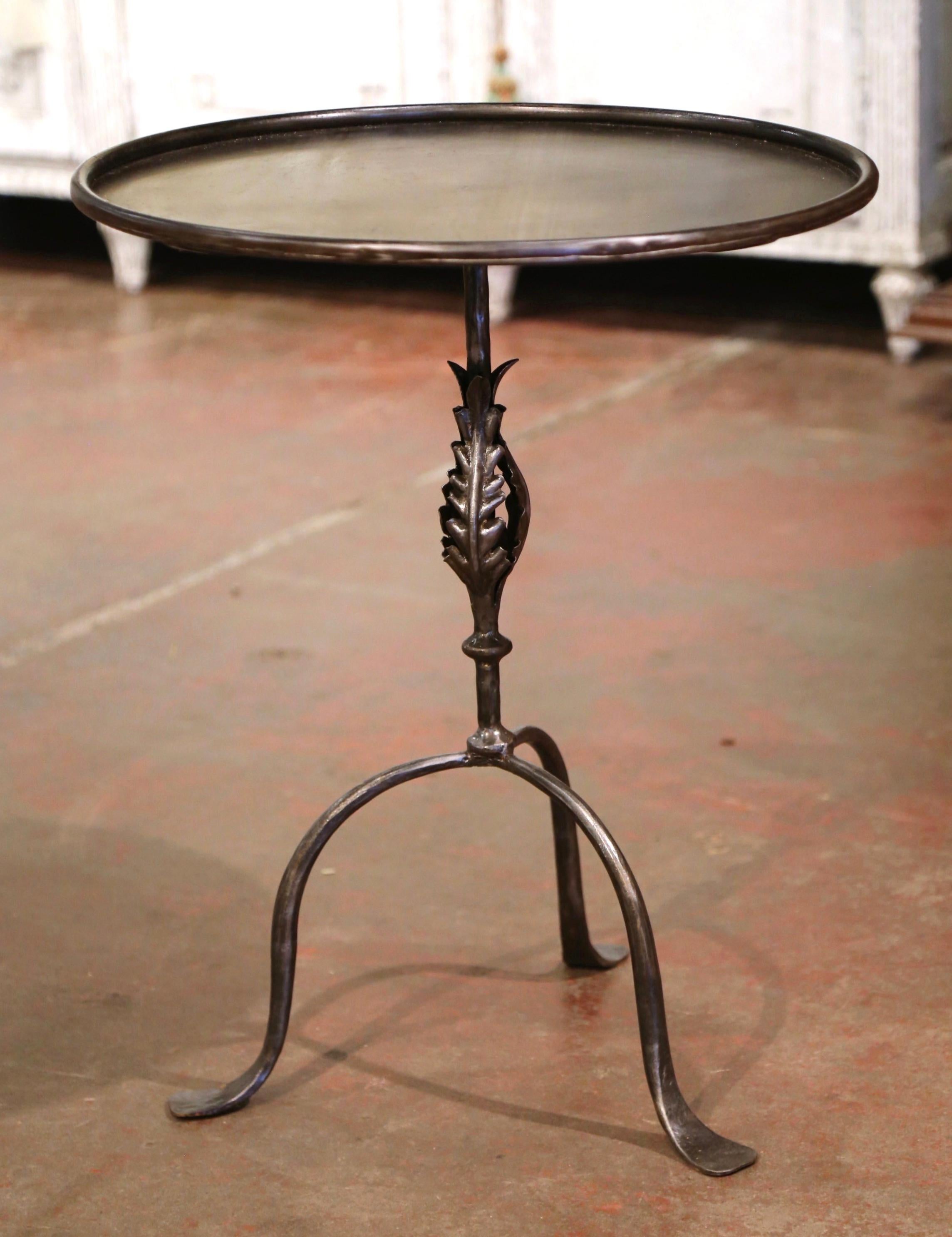 This elegant, antique pedestal table was crafted in Southern France, circa 1920. The intricate martini table features a central pedestal stem embellished with acanthus leaf decor over three scrolled legs ending with small feet. The serving table is