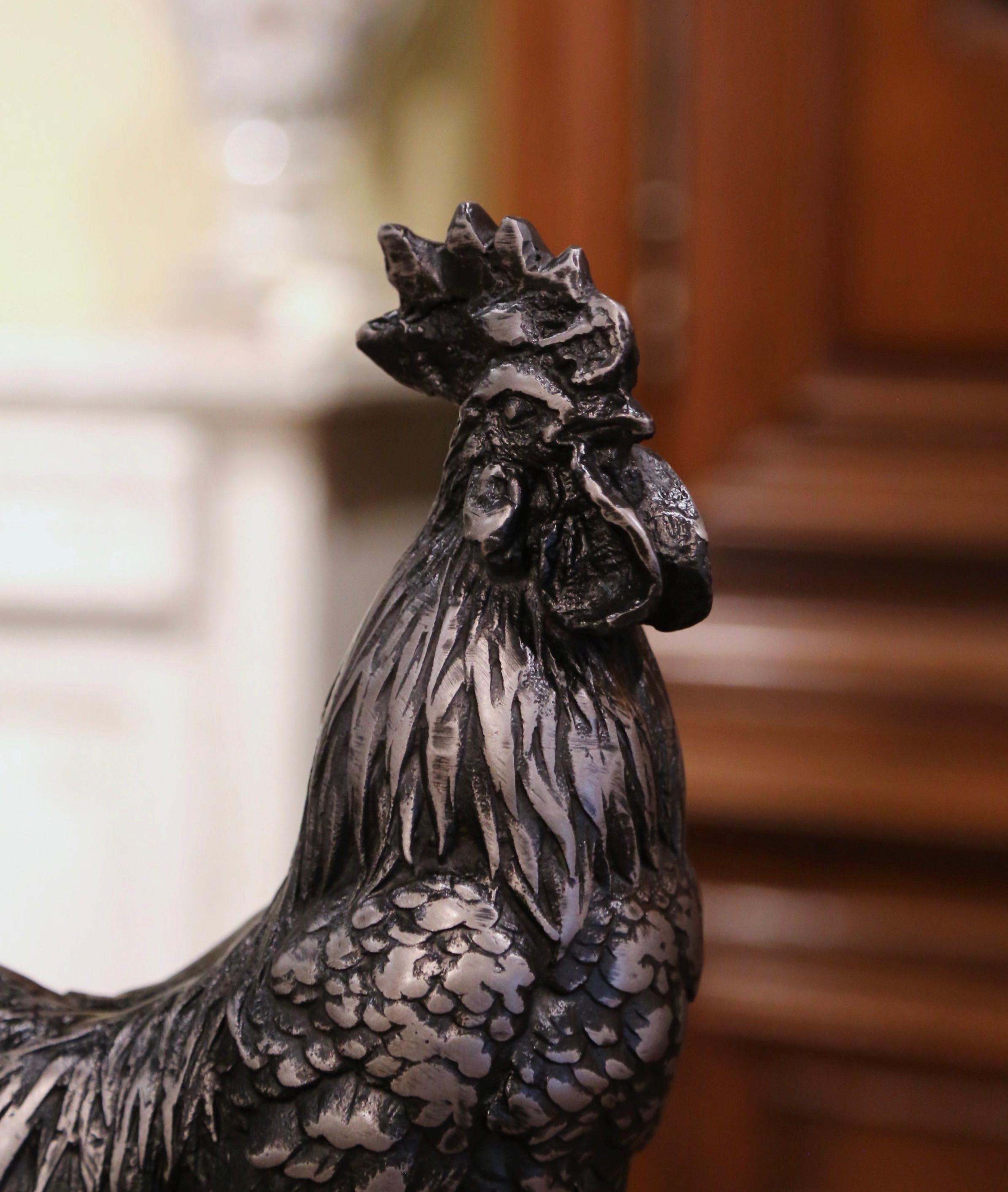 Decorate a kitchen or breakfast room with this antique iron rooster. Crafted in France, circa 1920, the tall sculpture features a majestic chanticleer rooster standing on a round base. The elegant bird, symbol of France, is in excellent condition