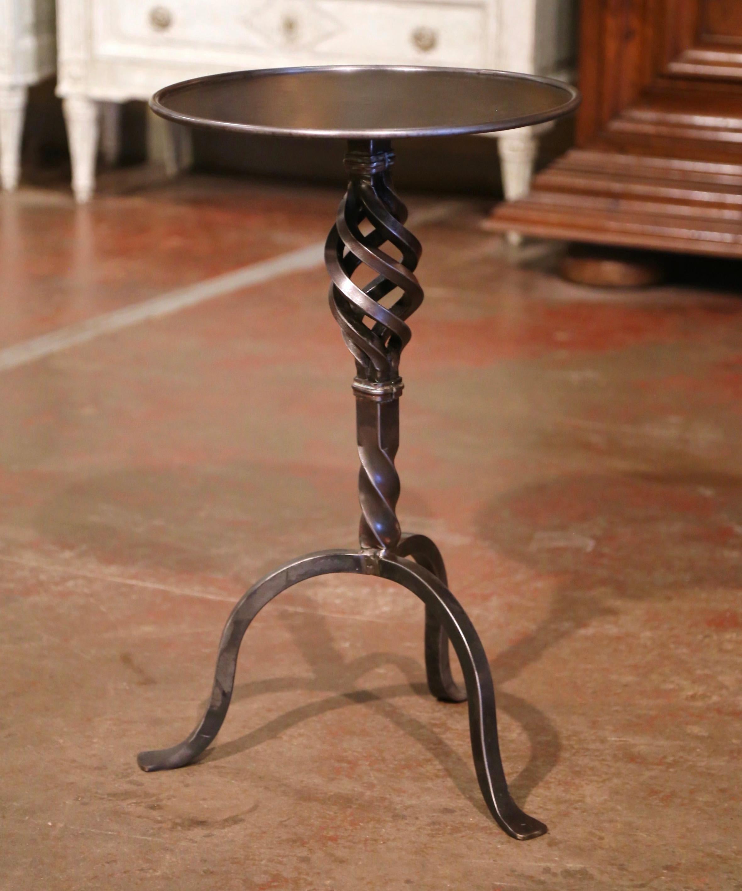 This elegant, antique Gothic pedestal table was crafted in Southern France, circa 1920. The intricate martini table features a forged central pedestal stem embellished with a spun knob over turned decor, with three curved legs ending with flat feet.