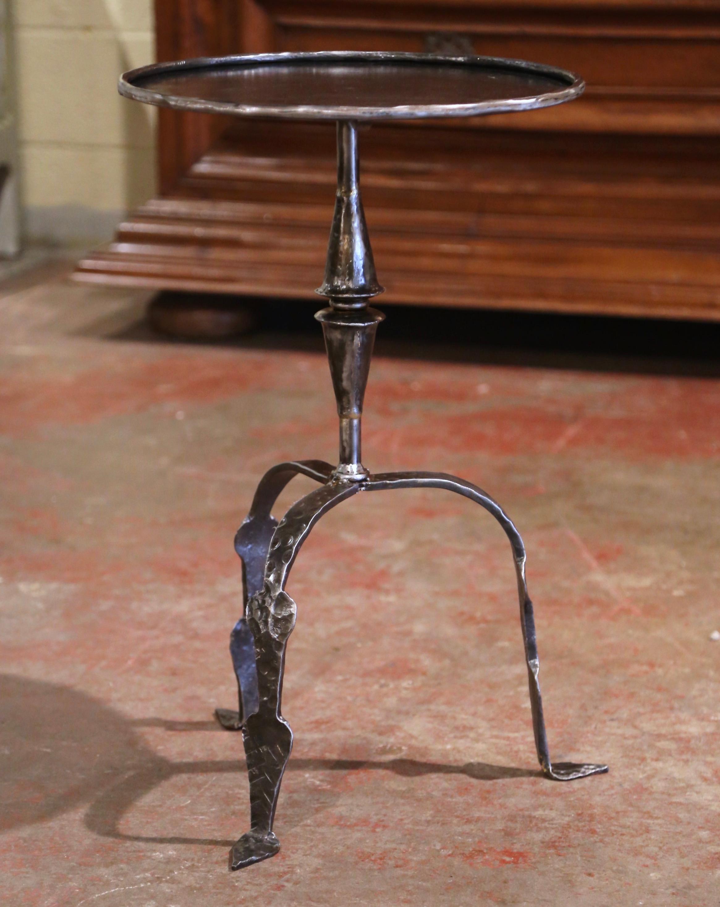 This elegant, antique Gothic pedestal table was crafted in Southern France, circa 1920. The intricate martini table features a forged central pedestal stem embellished with turned decor over three scrolled legs ending with flat feet. The serving