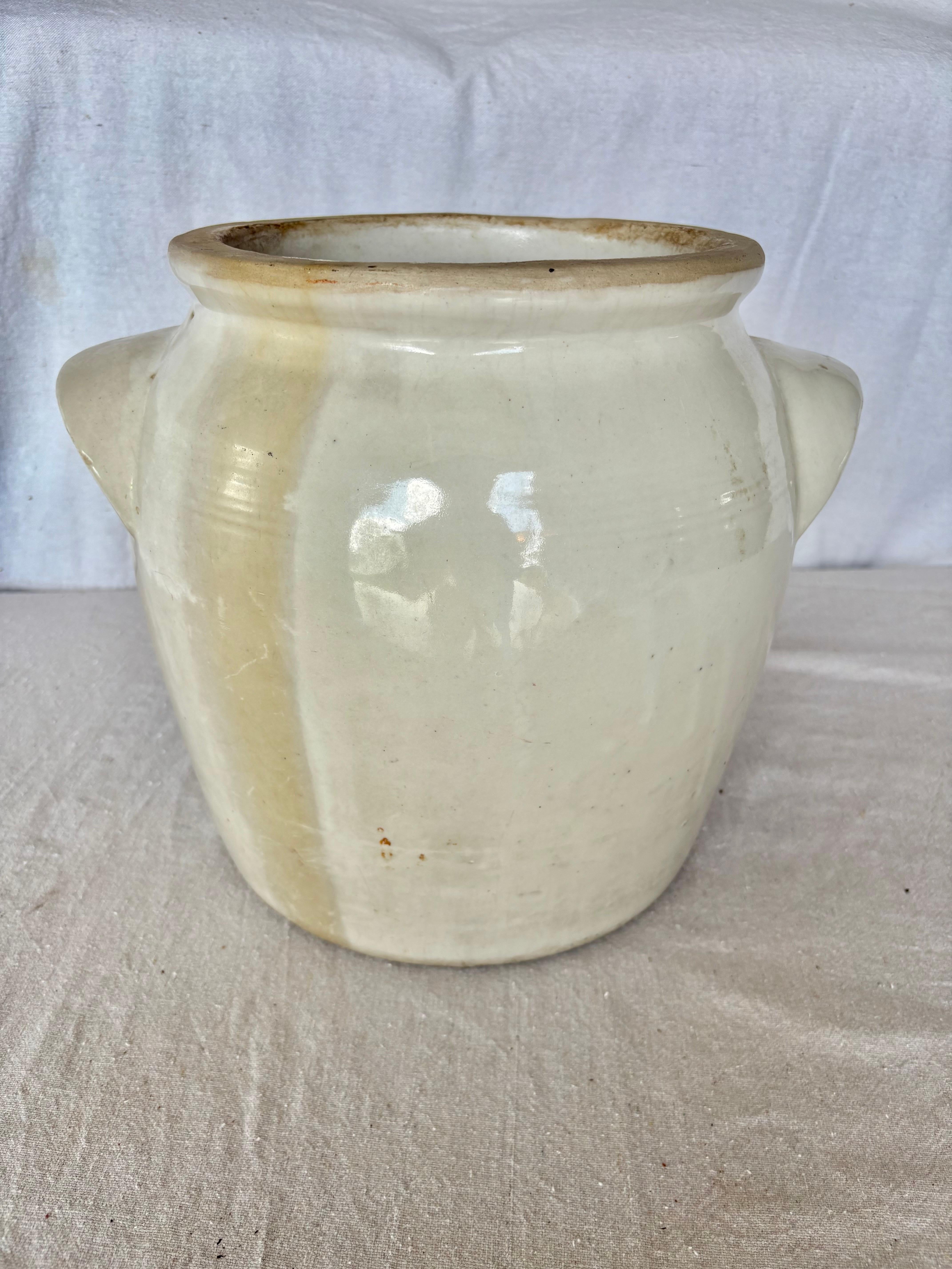 Found in the South of France, this Vintage French Confit Pot was crafted in the early 1900's. It is glazed on the interior and exterior in a gorgeous gray/tan. The piece is adorned with two curved side handles and a nicely formed top opening. This