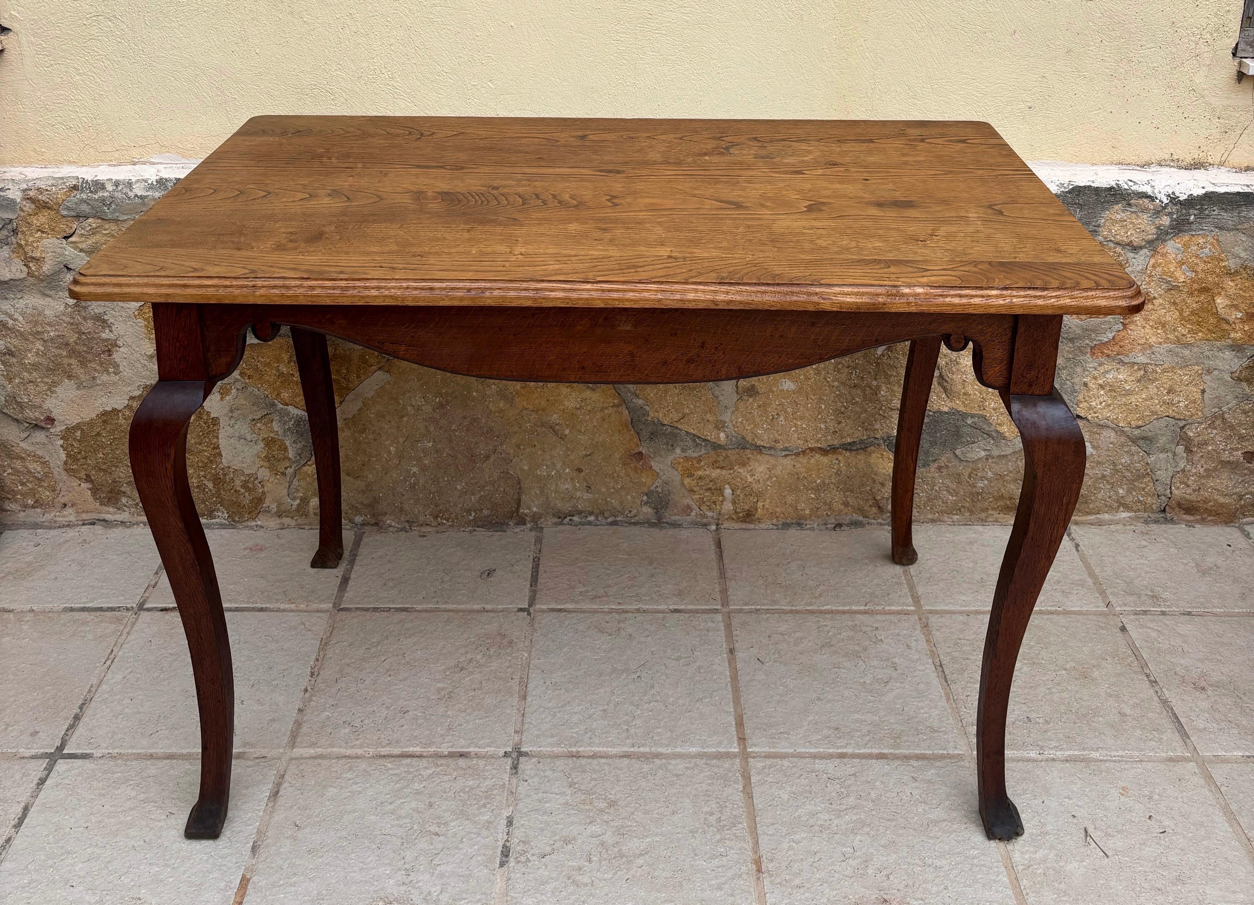 Elegant early 20th-century French Provincial console table crafted in solid oak, featuring graceful cabriole legs and a beautifully shaped apron. The silhouette is inspired by Louis XV revival design, combining soft curves with a refined rustic