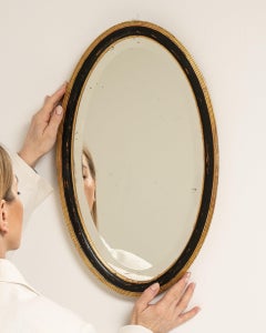 Early 20th Century French Provincial Oval Mirror, Black Giltwood Frame