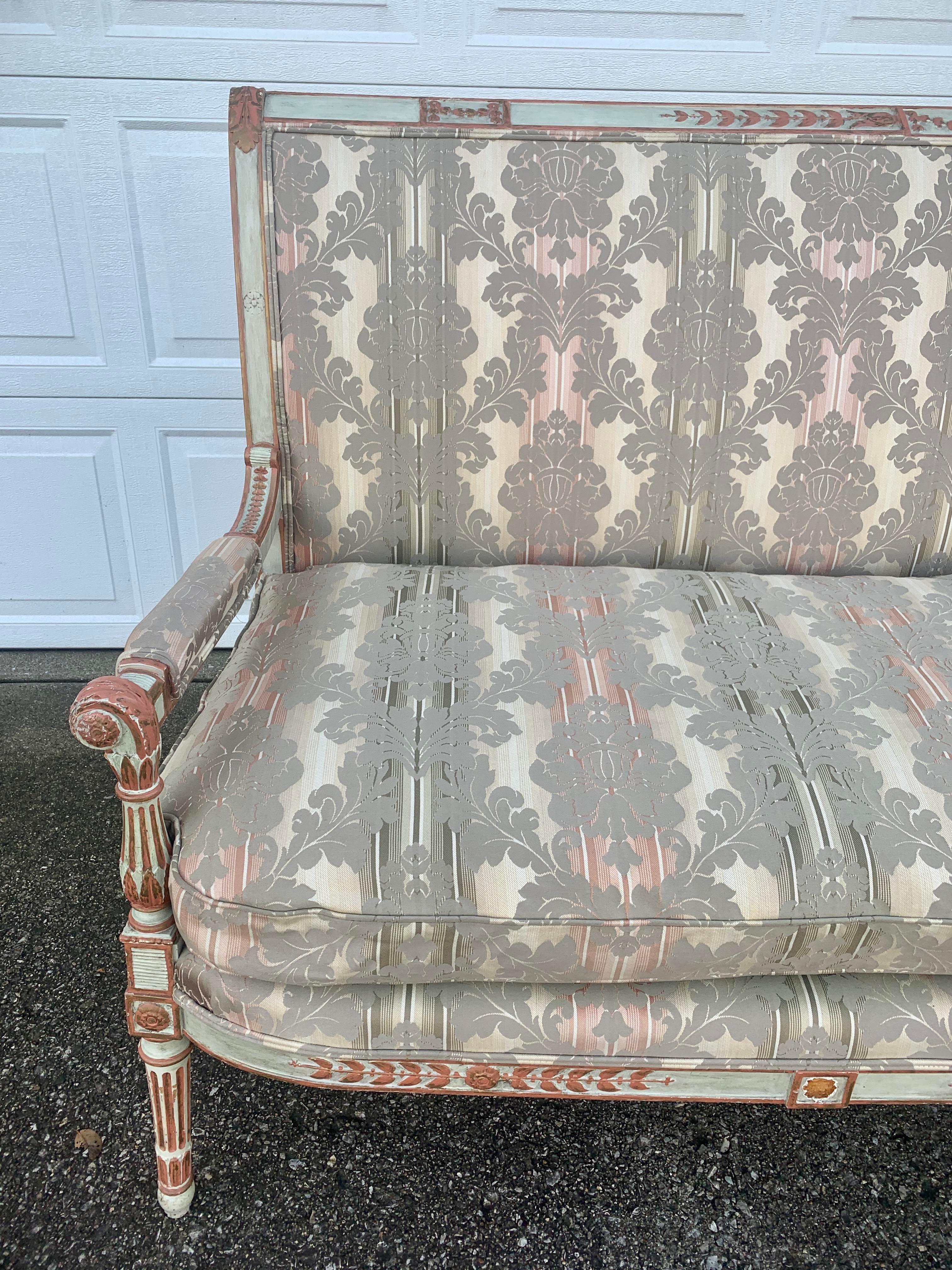 A gorgeous French provincial sofa

Circa early 20th century

Carved wood frame with original paint, damask upholstery, and removable down filled cushion

Measures: 70.25