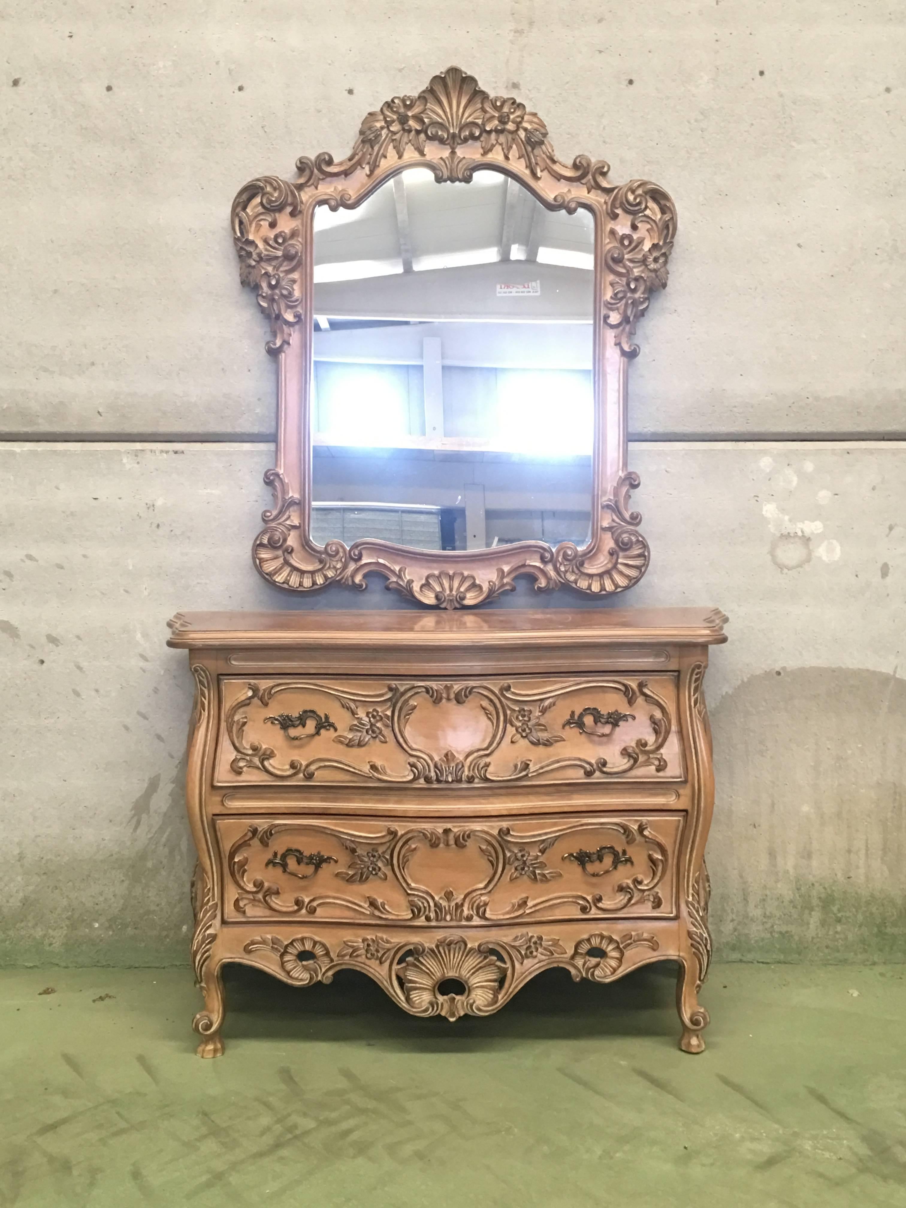 Elegant and incredibly beautiful with matched console. Created in Lyon in 1820, the mirror exemplifies the style of central France with a floral carvings and noticeable artistic character. The carved pediment is decorated with shells and flowers,