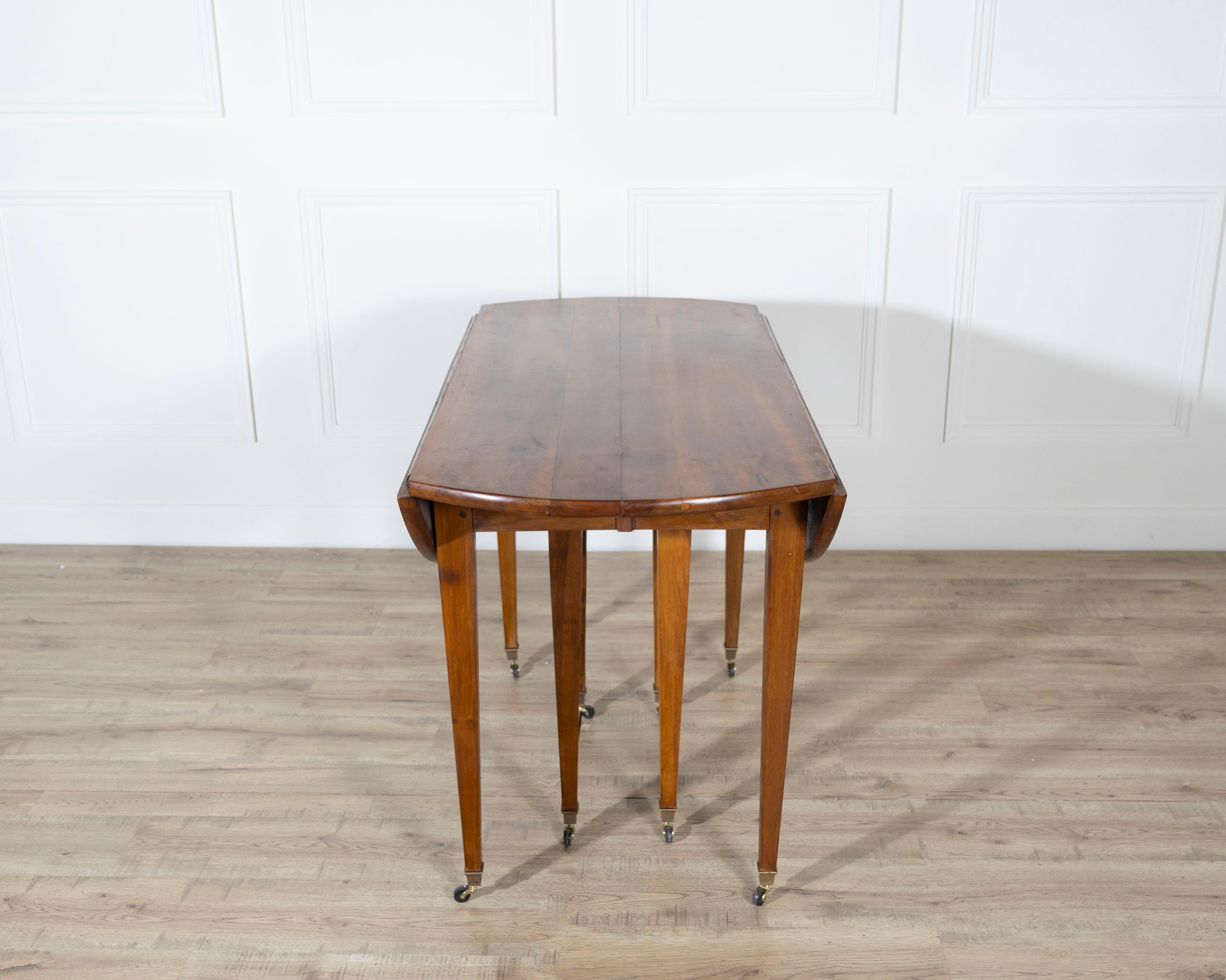 A beautifully crafted early 20th-century French extension dining table in the Restoration style, made from richly grained solid walnut. Measuring an impressive eight feet when fully extended, this elegant piece offers both grandeur and versatility —
