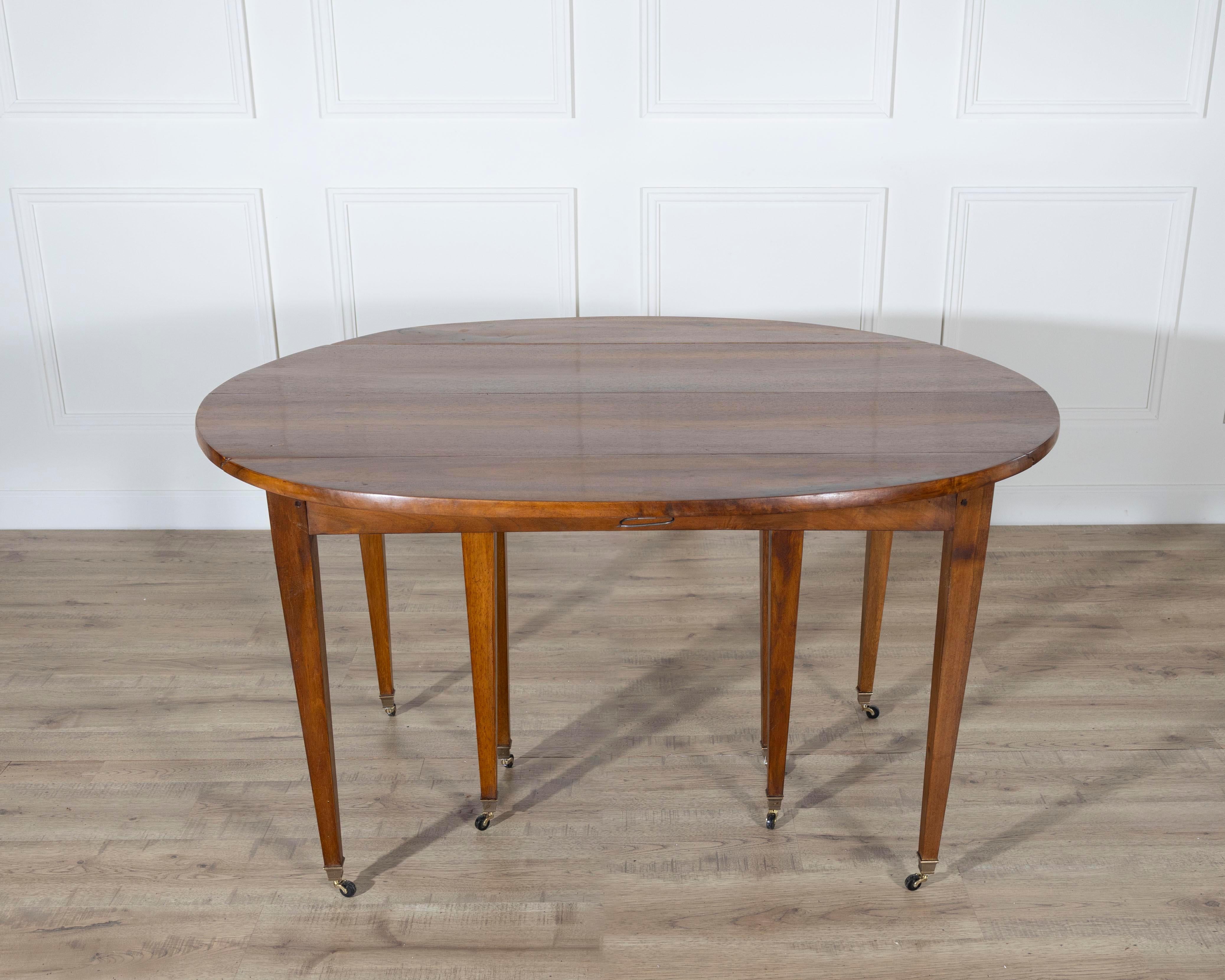 A beautifully crafted early 20th-century French extension dining table in the Restoration style, made from richly grained solid walnut. Measuring an impressive eight feet when fully extended, this elegant piece offers both grandeur and versatility —