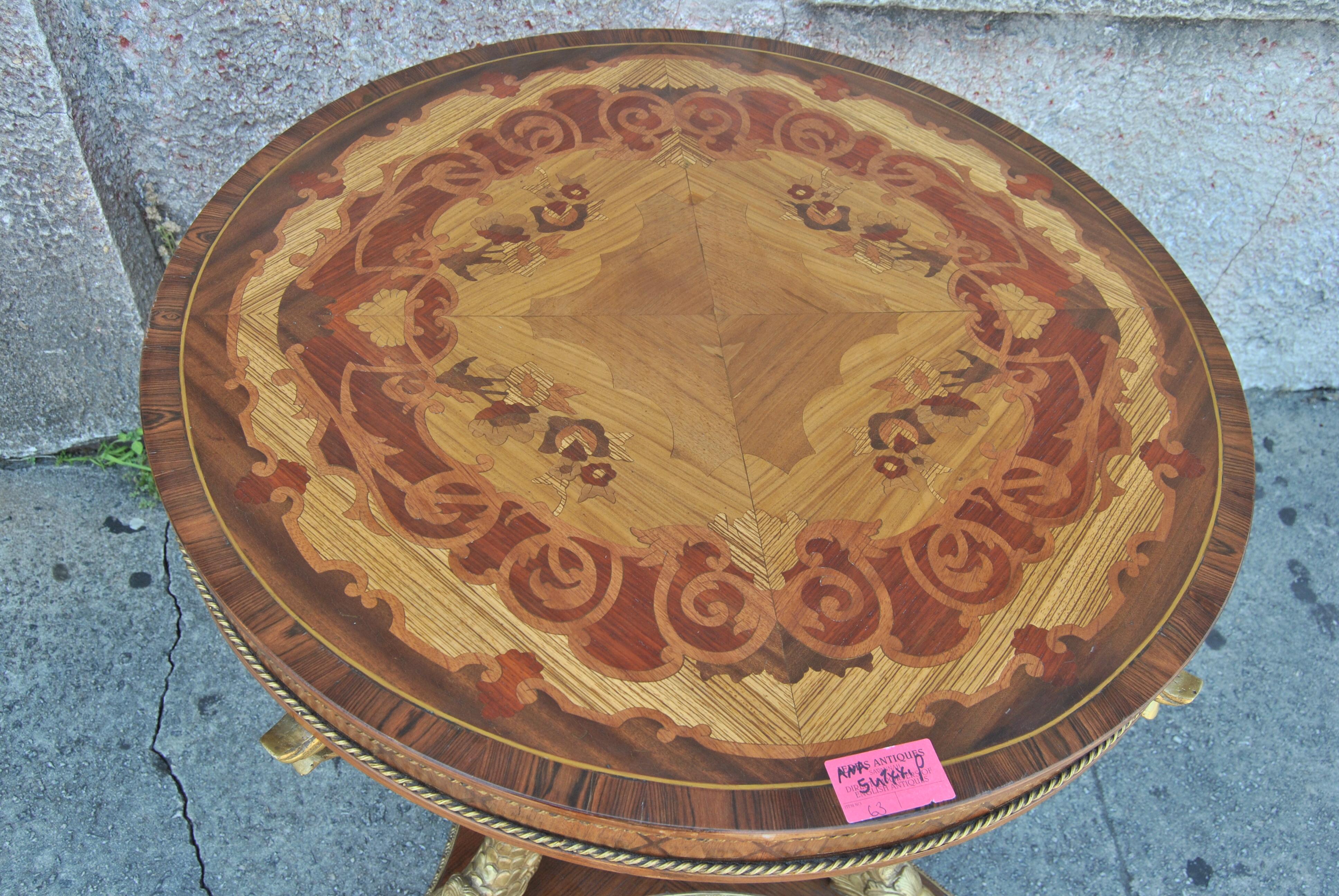 This is a center table, end table, side table, hall table that was made in France, circa 1910. The table is of the finest quality imaginable. The top of the table has a Rosewood Banding and is highly inlaid in many various woods including Satinwood,