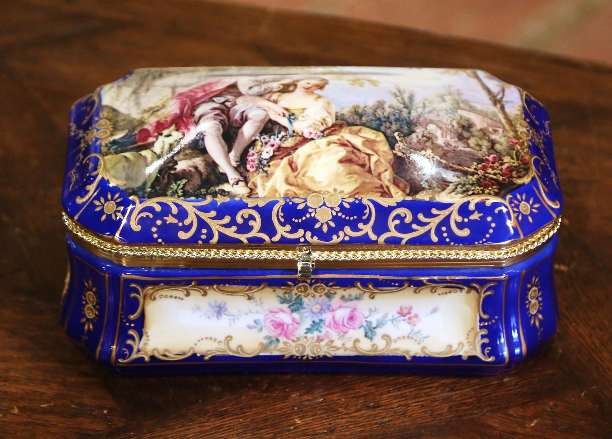 Decorate a master bathroom or powder room with this colorful antique jewelry box; crafted in the style of Sèvres, France circa 1870, the porcelain bombe casket with cobalt blue and gilt border, features a hand painted pastoral scene after Francois