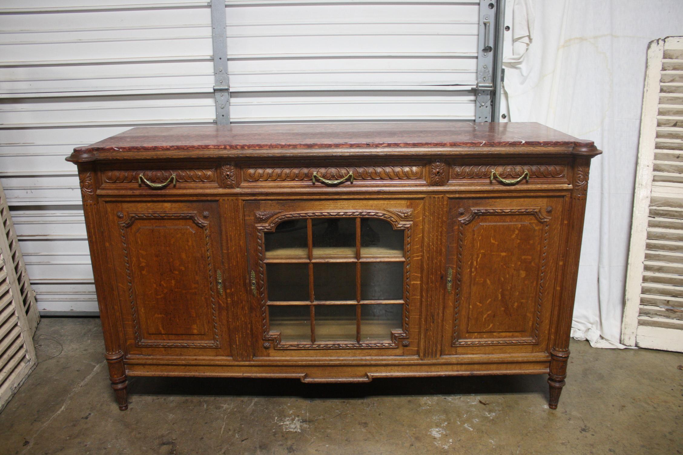 Very nice and interesting sideboard with glasses in the center door and a wonderful marble top.