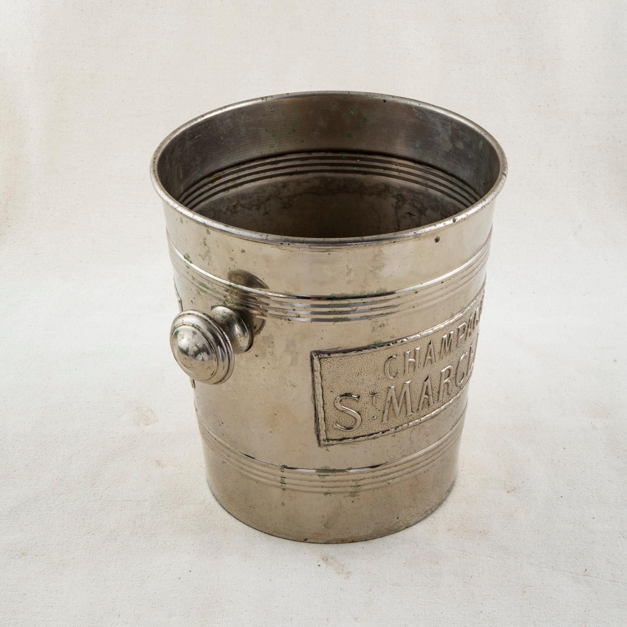 This French Art Deco Period silver plate champagne bucket from the early-twentieth century bears the name of the champagne producer St. Marceaux. A knob handle on each side allows for easy carrying. Stamped with the hallmark Unis France on the