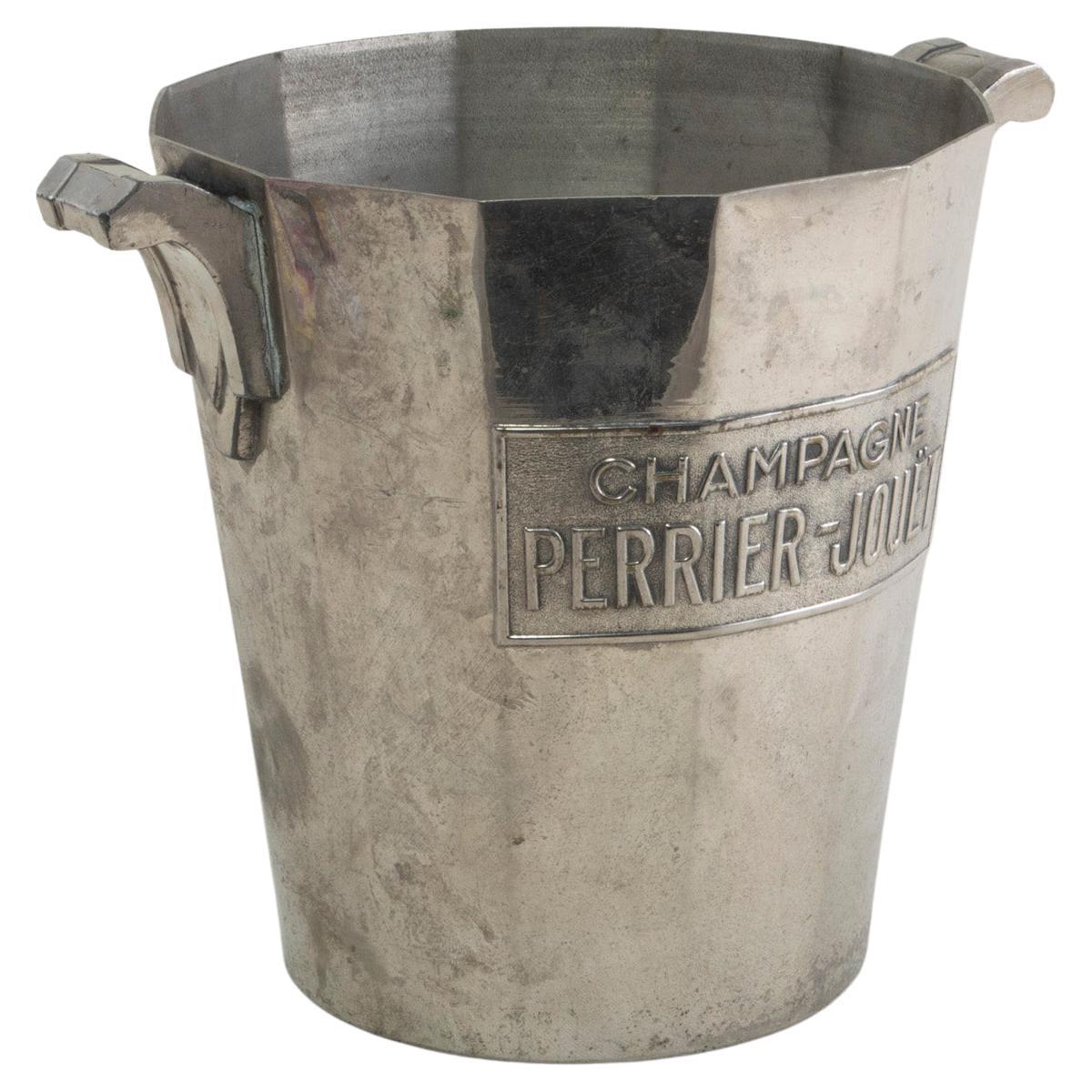 This early twentieth century French silver plate champagne bucket features the name of the champagne producer, Perrier Jouet. The bottom is stamped Argit Paris, Made in France. Art Deco handles allow for easier carrying and presentation. A wonderful