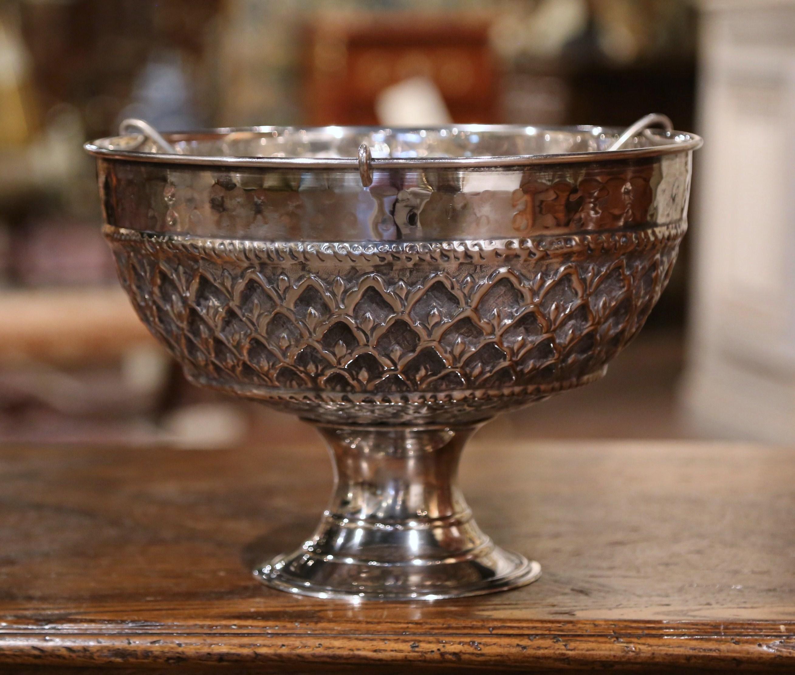 Keep your wine or champagne chilled in style with this elegant round bucket; crafted in France circa 1950 and round in shape, the bowl features intricate repousse decorative motifs; inside the bucket, a removable three bottle tray compartment sits