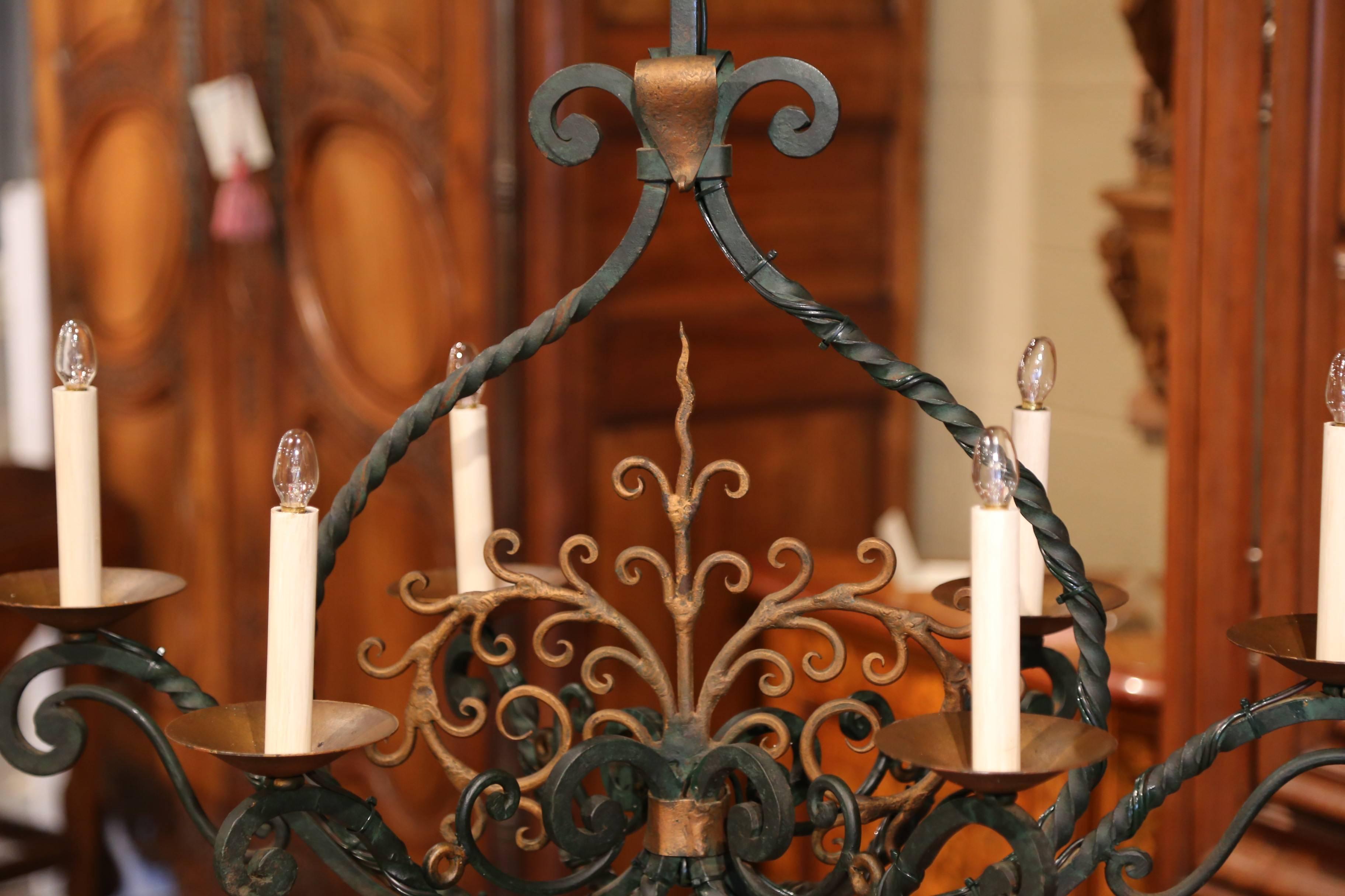 This elegant, scrolling, oblong chandelier would make a lovely addition to a home of any style. Crafted from iron, the light fixture was made in France, circa 1920. The light, expressive chandelier features six scrolled arms and curling center